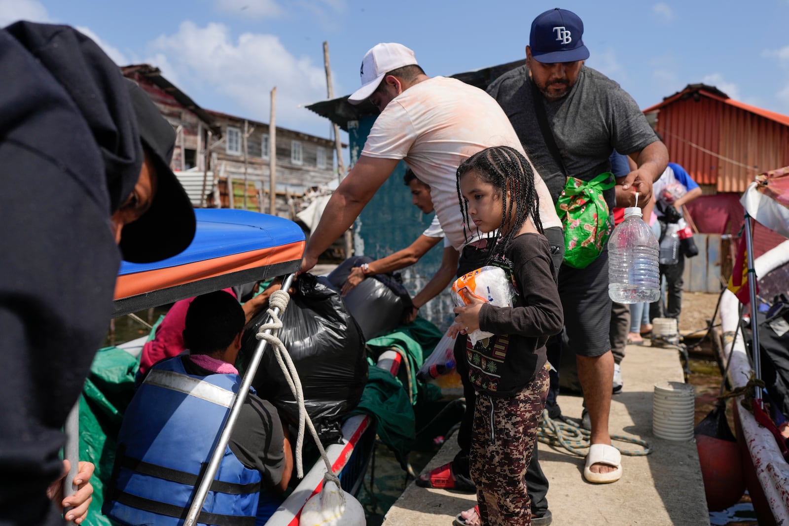 Venezuelan migrants board boats to Colombia on Panama's Caribbean coastal island of Gardi Sugdub, Sunday, Feb. 23, 2025, after turning back from southern Mexico where they gave up hopes of reaching the U.S. amid President Trump's crackdown on migration. (AP Photo/Matias Delacroix)