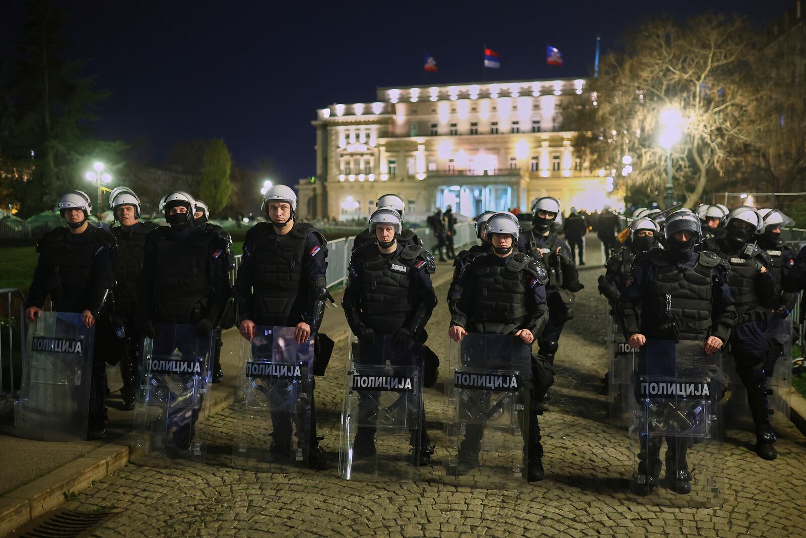 Serbian anti-riot police stand near the Parliament building ahead of a major rally this weekend in downtown Belgrade, Serbia, Friday, March 14, 2025. (AP Photo/Armin Durgut)