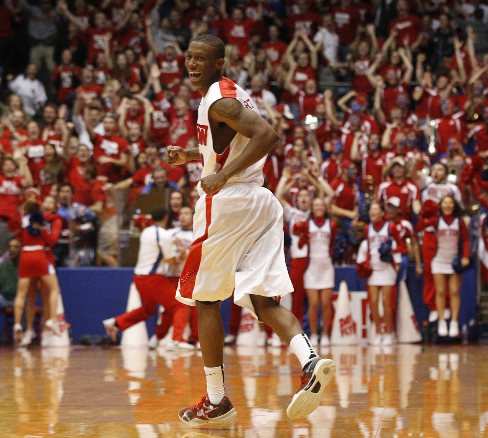 Jordan Sibert smiles as he runs back up court after a game-winning 3-pointer with 1 second left against IPFW on Saturday, Nov. 9, 2013, at UD Arena. David Jablonski/Staff