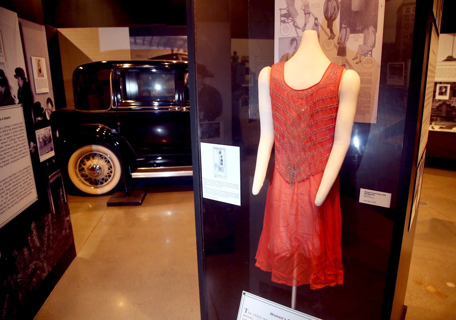 An orange crepe flapper dress with rhinestones is among the artifacts at Carillon Historical Park's exhibition, Bootleggers, Bandits, and Badges: From Dry Times to Hard Times in Dayton, Ohio." LISA POWELL / STAFF