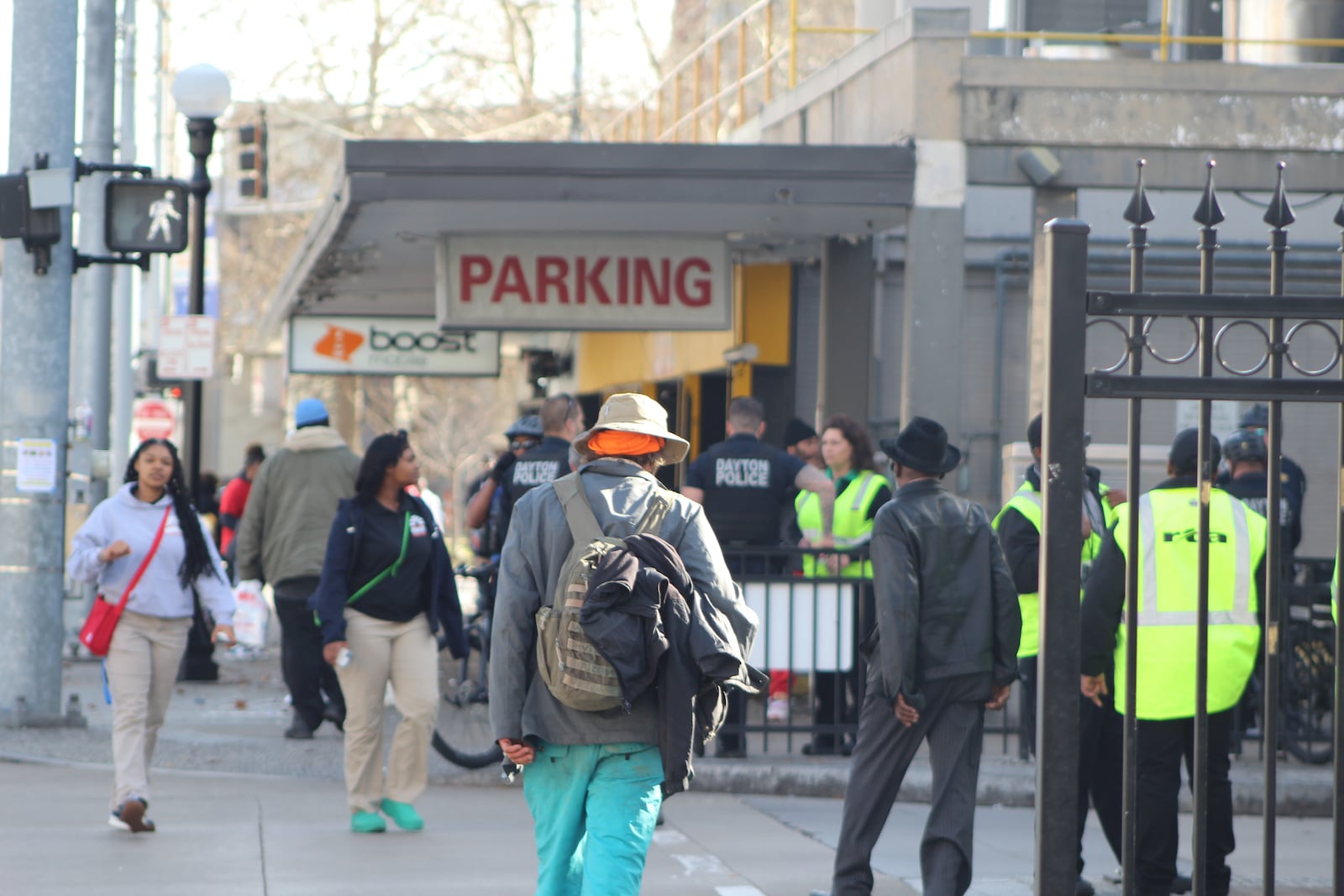 People walk by the Wright Stop Plaza Transit Center on South Jefferson Street on Thursday, Feb. 23, 2023. Dayton police and Greater Dayton RTA security personnel watch over the  area. CORNELIUS FROLIK / STAFF