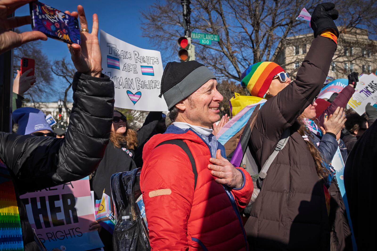 Joe Ronayne, of Cambridge, Mass., puts his hand on his heart while listening to an 11-year-old talk about her experiences as a trans girl, as he rallies with other supporters of transgender rights by the Supreme Court, Wednesday, Dec. 4, 2024, while arguments are underway in a case regarding a Tennessee law banning gender-affirming medical care for transgender youth. (AP Photo/Jacquelyn Martin)