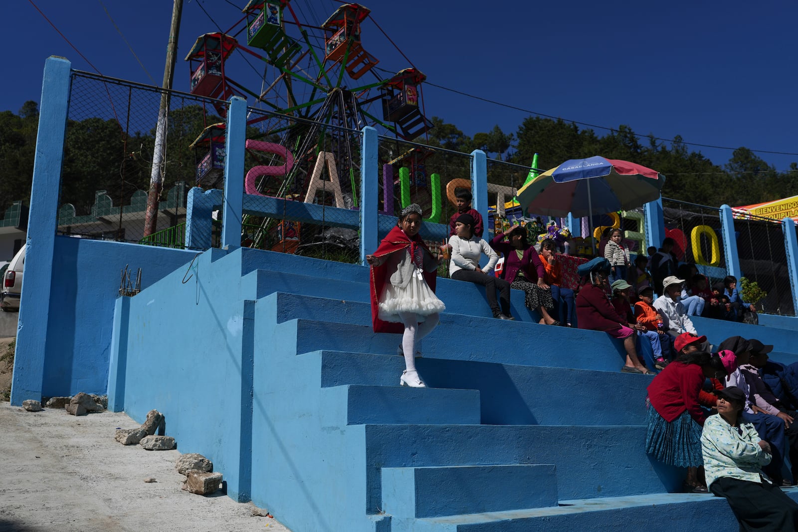 People watch the performance of The Dance of the Conquest of Guatemala, depicting Spain's 1524 invasion of the K'iche' kingdom in Tejutla, in Guatemala's San Marcos department, on the feast day of the Black Christ of Esquipulas, Wednesday, Jan. 15, 2025. (AP Photo/Moises Castillo)