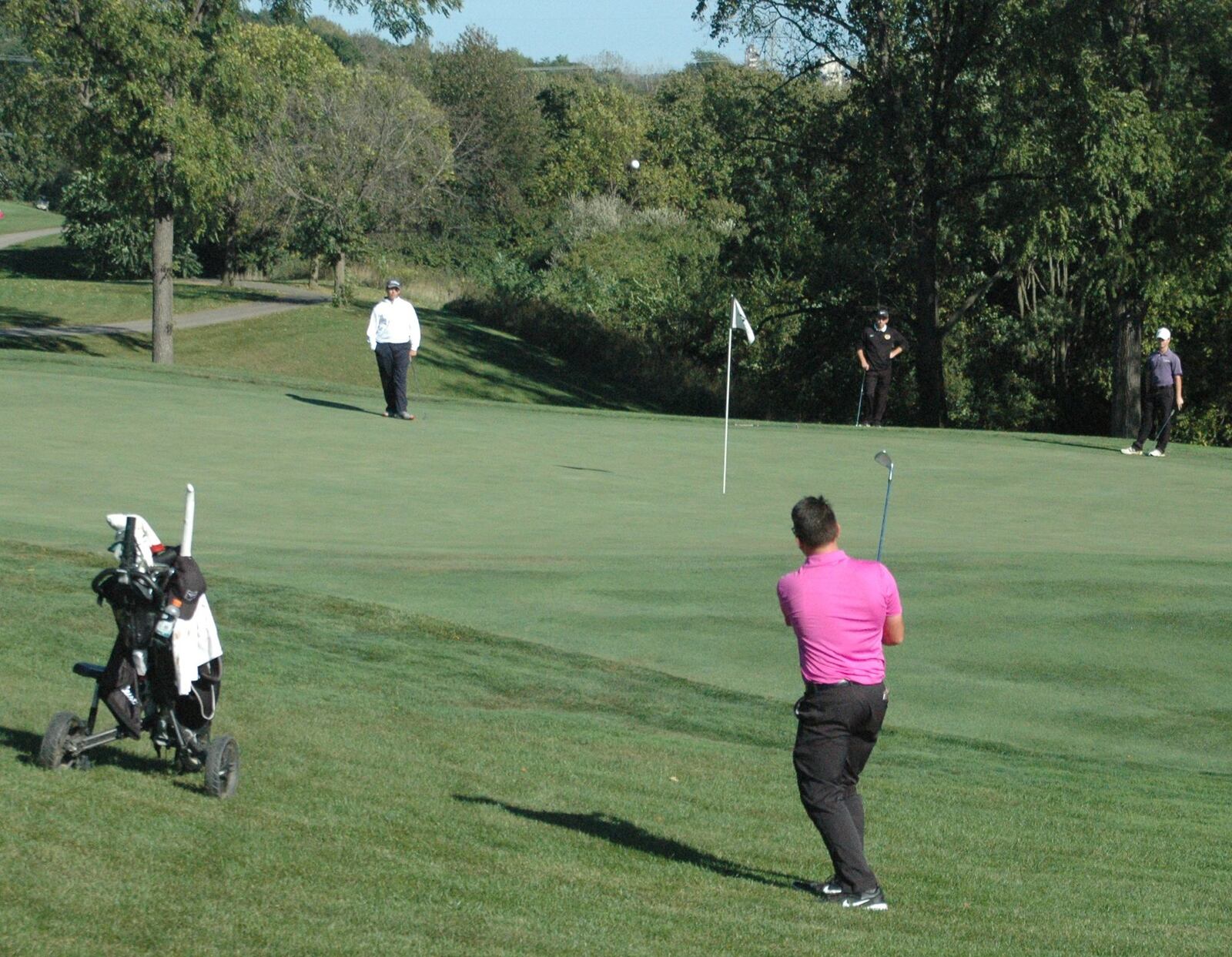 Lakota East’s Joe Wilson chips onto the 18th green last week during the Division I district boys golf tournament at Beavercreek Golf Club. RICK CASSANO/STAFF