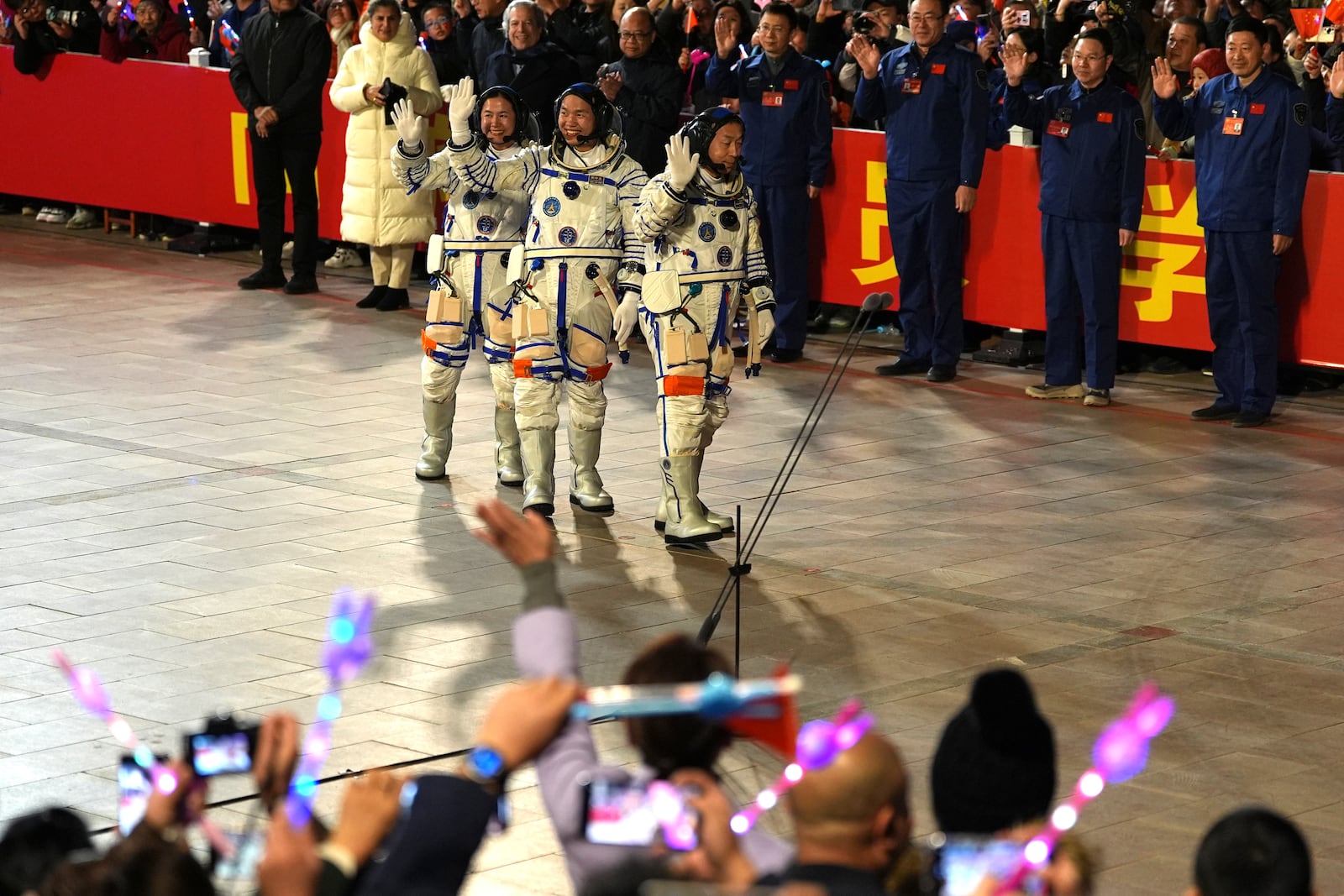 From left, Chinese astronauts Wang Haoze, Song Lingdong and Cai Xuzhe wave during the see-off ceremony for the Shenzhou-19 mission at the Jiuquan Satellite Launch Center in northwestern China in the early hours of Wednesday, Oct. 30, 2024. (AP Photo/Ng Han Guan)