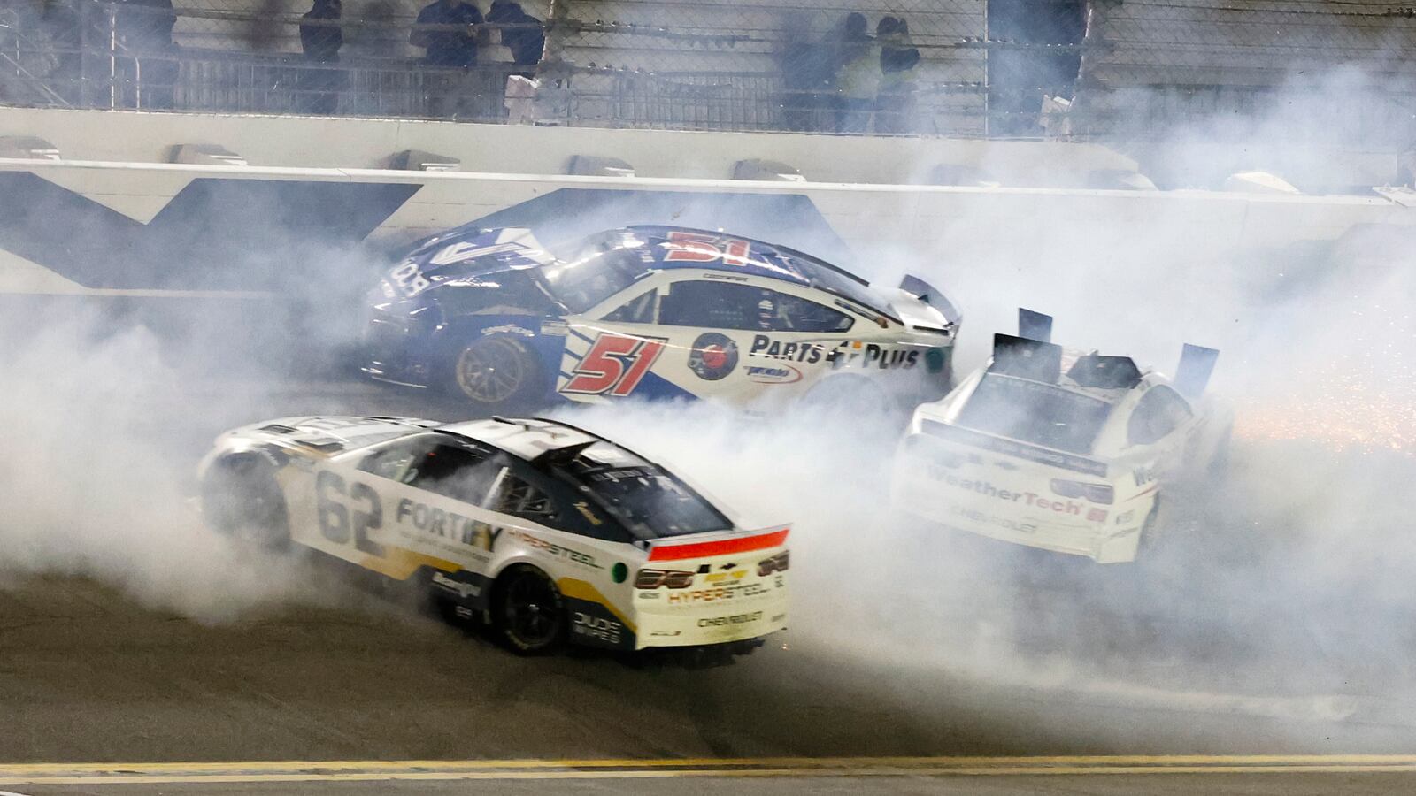 Anthony Alfredo (62), Cody Ware (51) and Shane Van Gisbergen, right, crash on the last lap of the second of two NASCAR Daytona 500 qualifying auto races at Daytona International Speedway, Thursday, Feb. 13, 2025, in Daytona Beach, Fla. (AP Photo/Terry Renna)