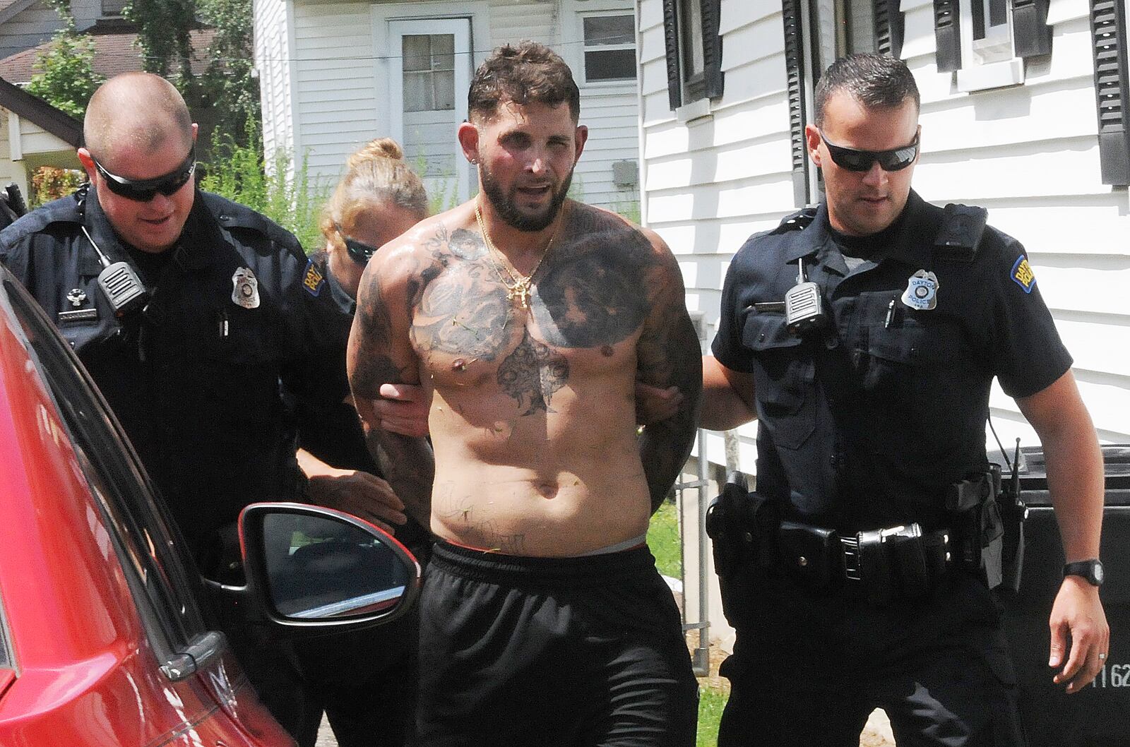 Dayton police caught a man who initially barricaded himself in a house and then tried to jump a fence to escape capture on Tuesday afternoon. MARSHALL GORBY\STAFF