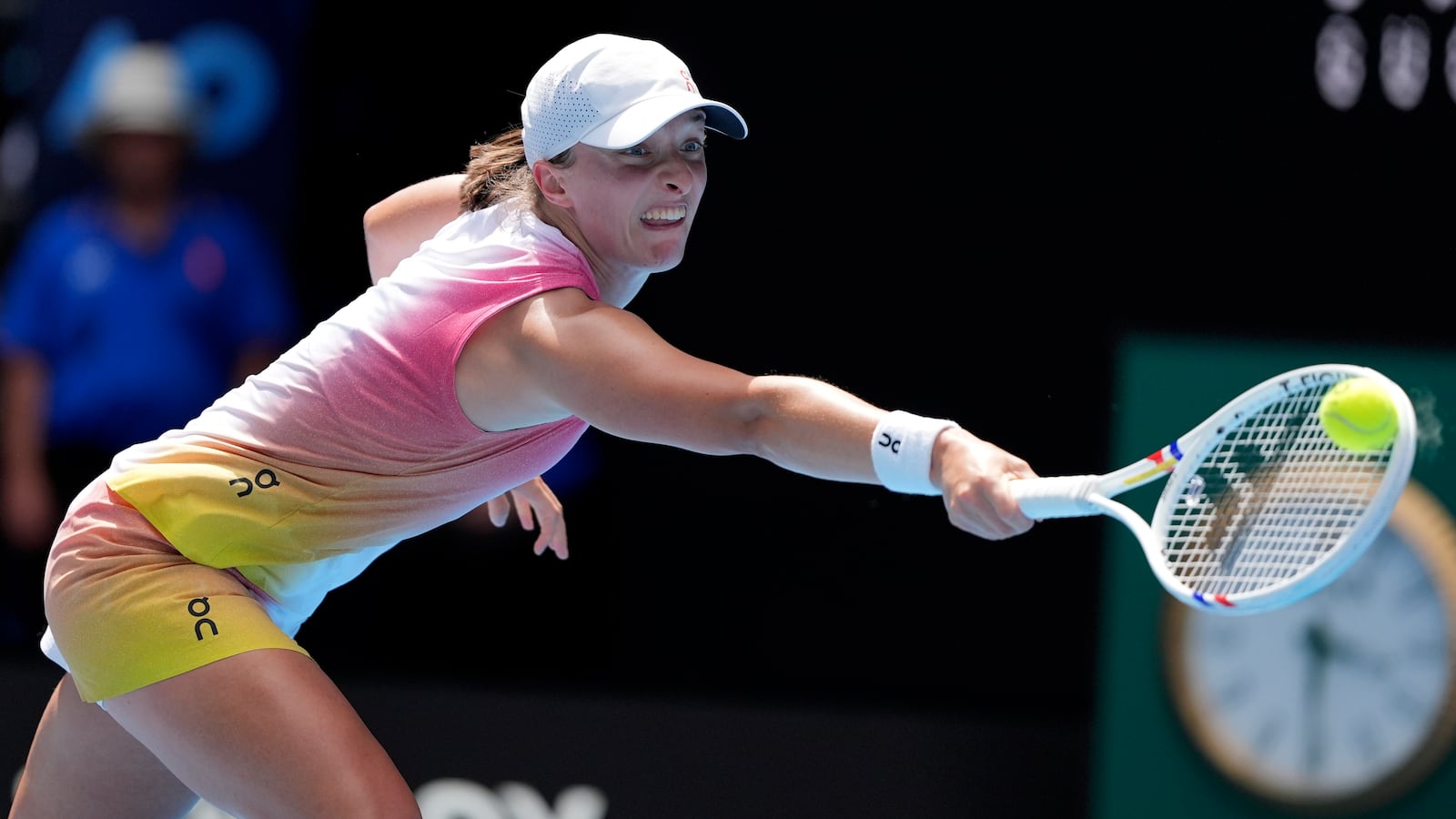 Iga Swiatek of Poland plays a backhand return to Katerina Siniakova of the Czech Republic during their first round match at the Australian Open tennis championship in Melbourne, Australia, Monday, Jan. 13, 2025. (AP Photo/Ng Han Guan)