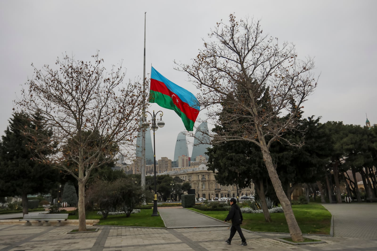 Azerbaijan's national flag at half-mast in the memory of victims of the Azerbaijan Airlines' Embraer 190 that crashed near the Kazakhstan's airport of Aktau, is seen in the center of Baku, Azerbaijan, Thursday, Dec. 26, 2024. (AP Photo/Aziz Karimov)