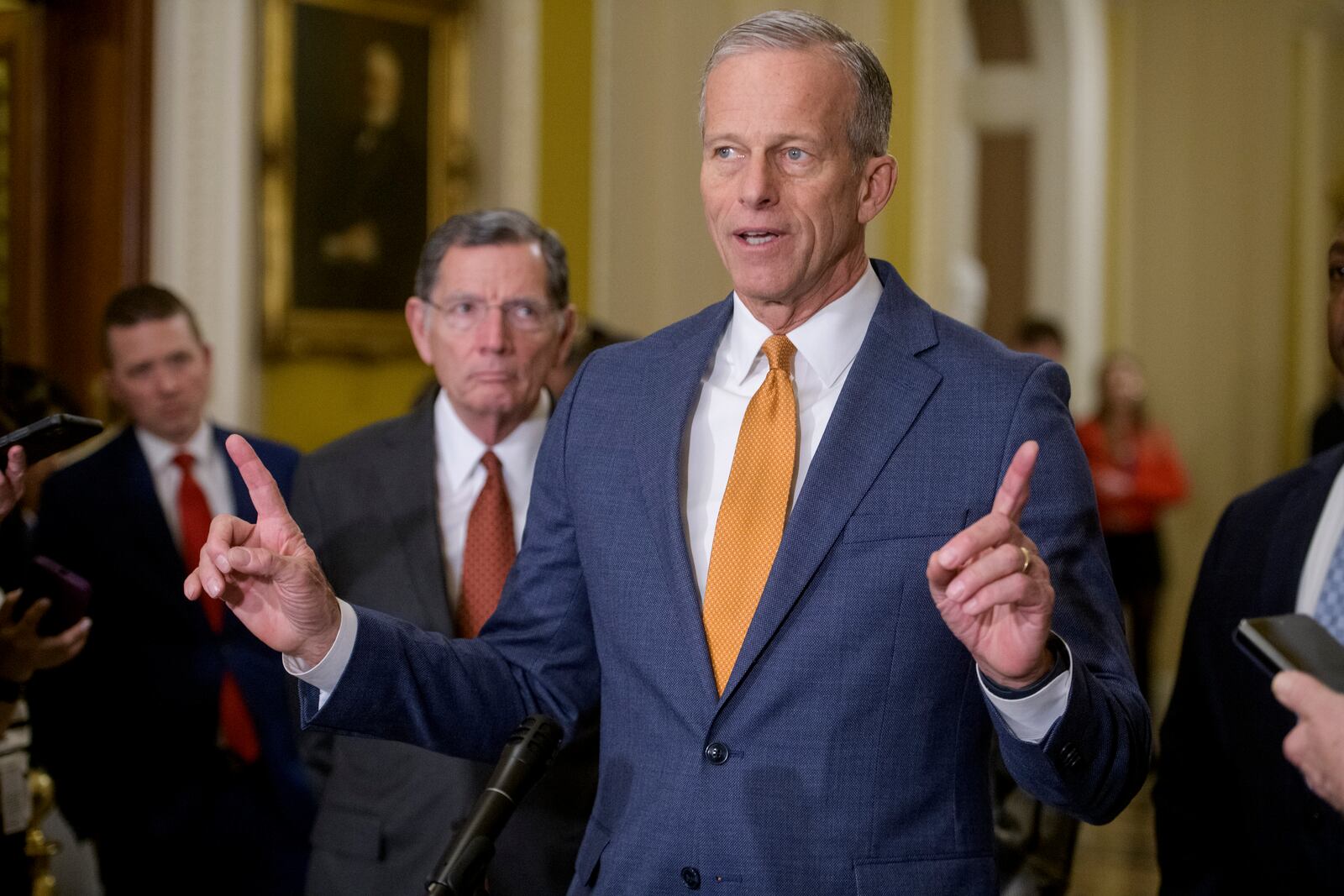 Sen. John Barrasso, R-Wyo., left, listens while Senate Majority Leader John Thune, R-S.D., speaks following the Senate Republican policy luncheon at the Capitol, Tuesday, Feb. 4, 2025, in Washington. (AP Photo/Rod Lamkey, Jr.)