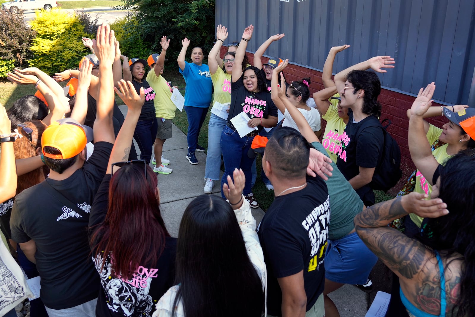 Members of a Latino support group celebrate as they meet together during a voter engagement event for the Latino community in Greensboro, N.C., Saturday, Sept. 21, 2024. (AP Photo/Chuck Burton)