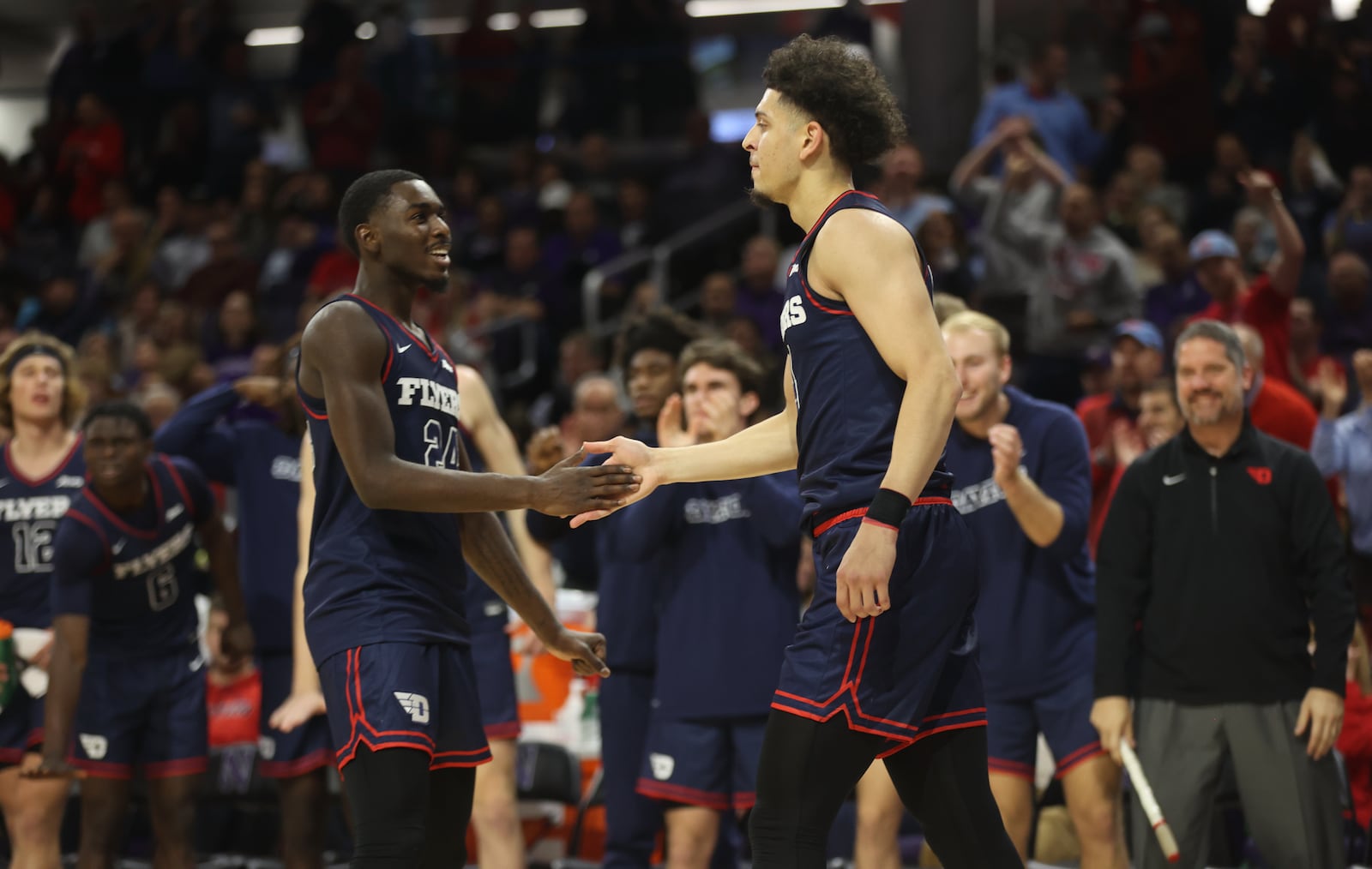 Dayton's Kobe Elvis, left, congratulates Koby Brea after Brea made a 3-pointer against Northwestern on Friday, Nov. 10, 2023, at Welsh-Ryan Arena in Evanston, Ill. David Jablonski/Staff