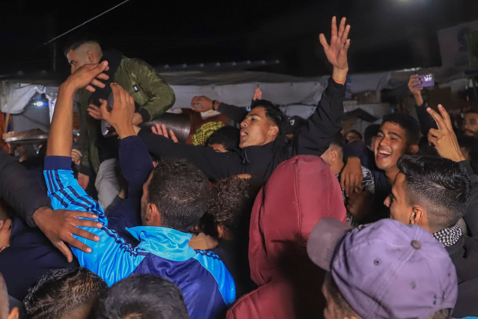 Palestinians celebrate the imminent announcement of a ceasefire deal between Hamas and Israel in Khan Younis, central Gaza Strip, Wednesday, Jan. 15, 2025.(AP Photo/(AP Photo/Mariam Dagga)