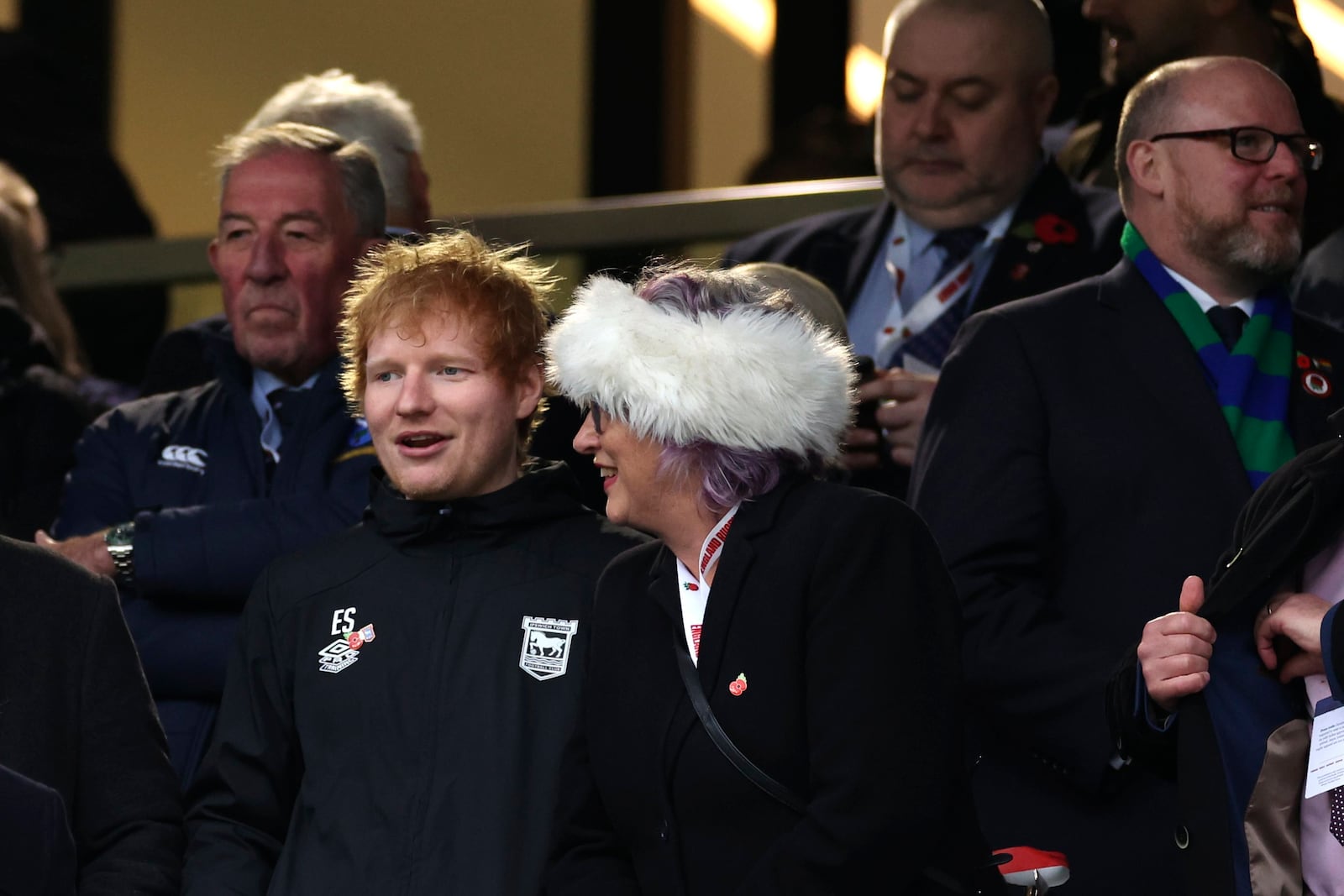 English singer-songwrite Ed Sheeran, left, watches the Autumn Nations series rugby union match between England and Australia, at Twickenham stadium, London Saturday, Nov. 9, 2024. (AP Photo/Ian Walton)