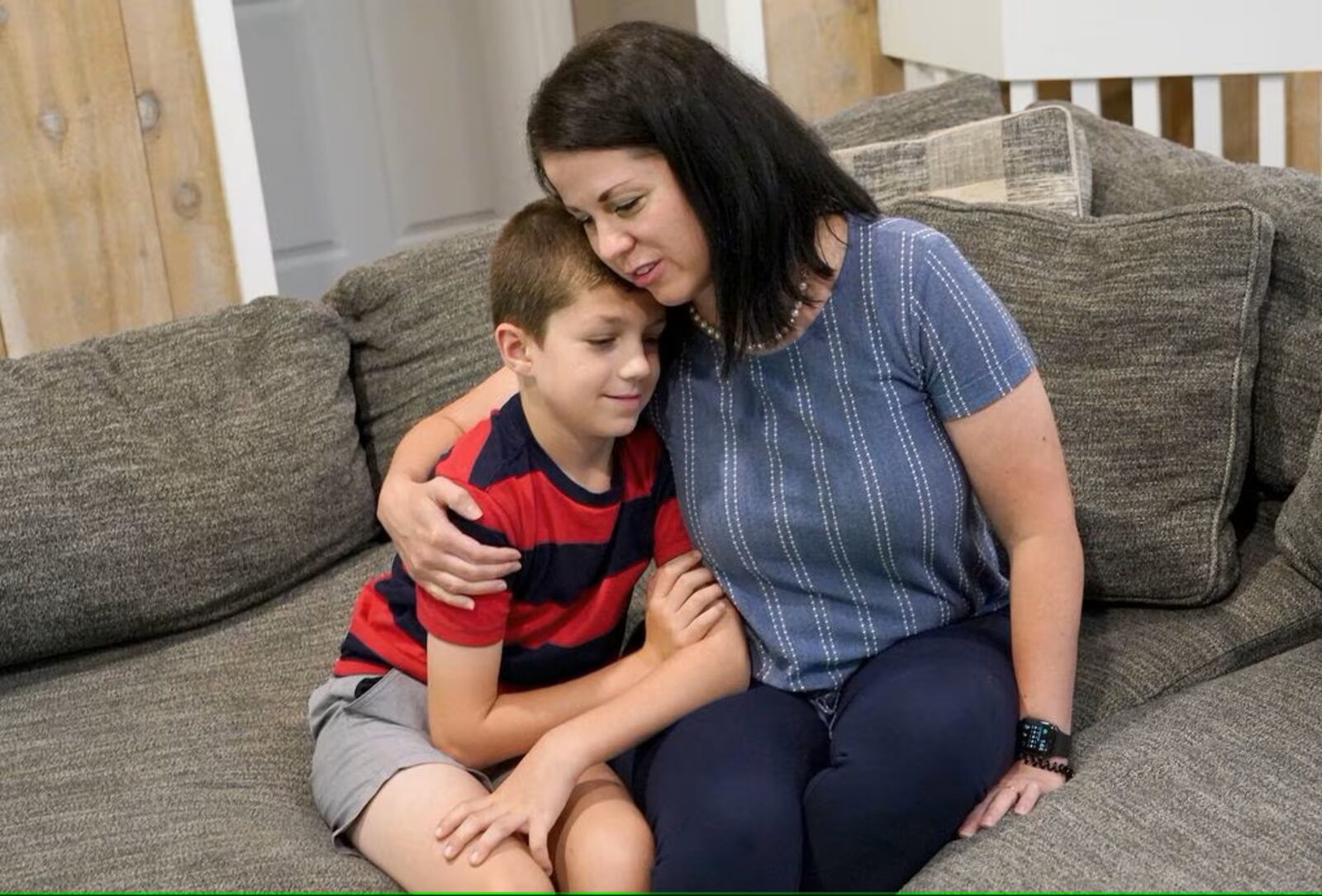 Misti Allison sits with her son, Blake, 8, at her home, Saturday, July 15, 2023, in East Palestine. Allison testified before a Senate committee in March concerning the Feb. 3 Norfolk Southern freight train derailment. (Matt Freed for the Atlanta Journal Constitution)