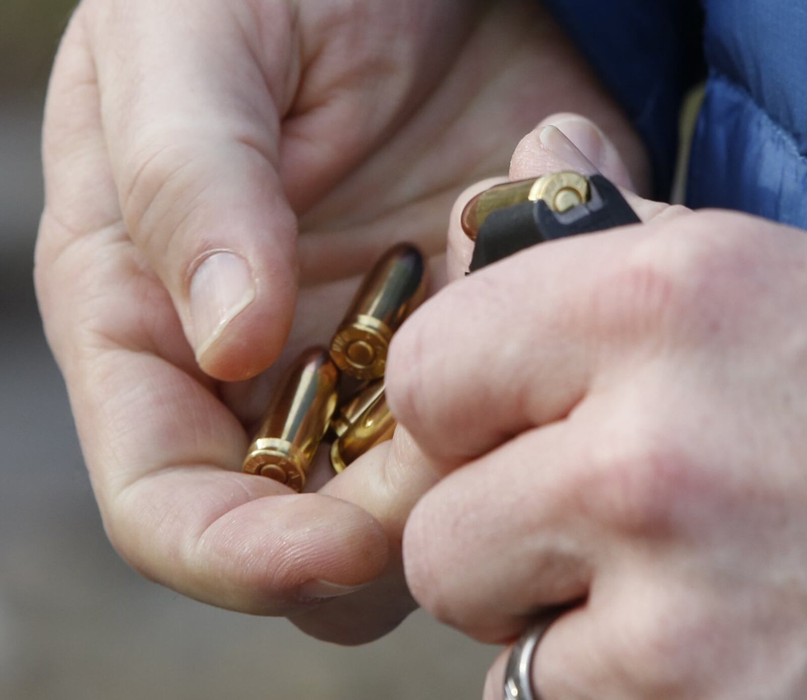 Evan English, president, Olde English Outfitters, loads a magazine for a 9mm handgun at the firing range. TY GREENLEES / STAFF