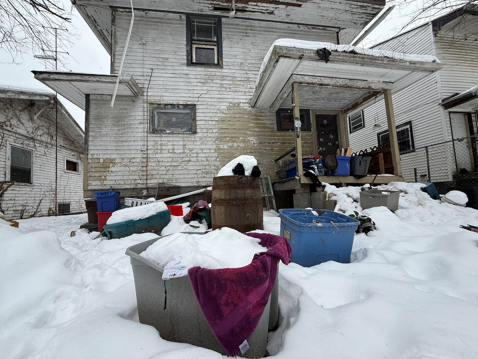 Residents have complained about trash in the backyard of this home on Faulkner Avenue in northwest Dayton. The backyard has discarded tires and tubs full of junk. CORNELIUS FROLIK / STAFF