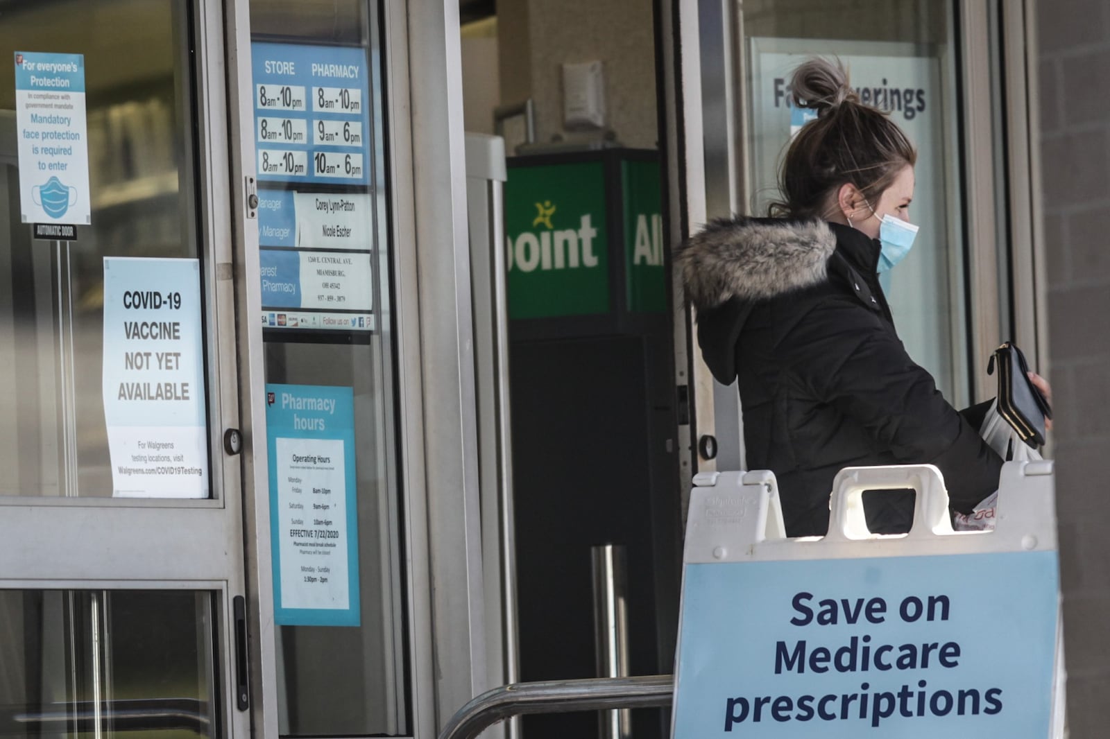 A customer leaves Walgreens on on Wayne Ave. Tuesday Dec.20, 2020. Signs on the door tells customers that the COVID-19 vaccine is not yet available in the store. A store clerk said the vaccine will arrive in March or April. JIM NOELKER/STAFF