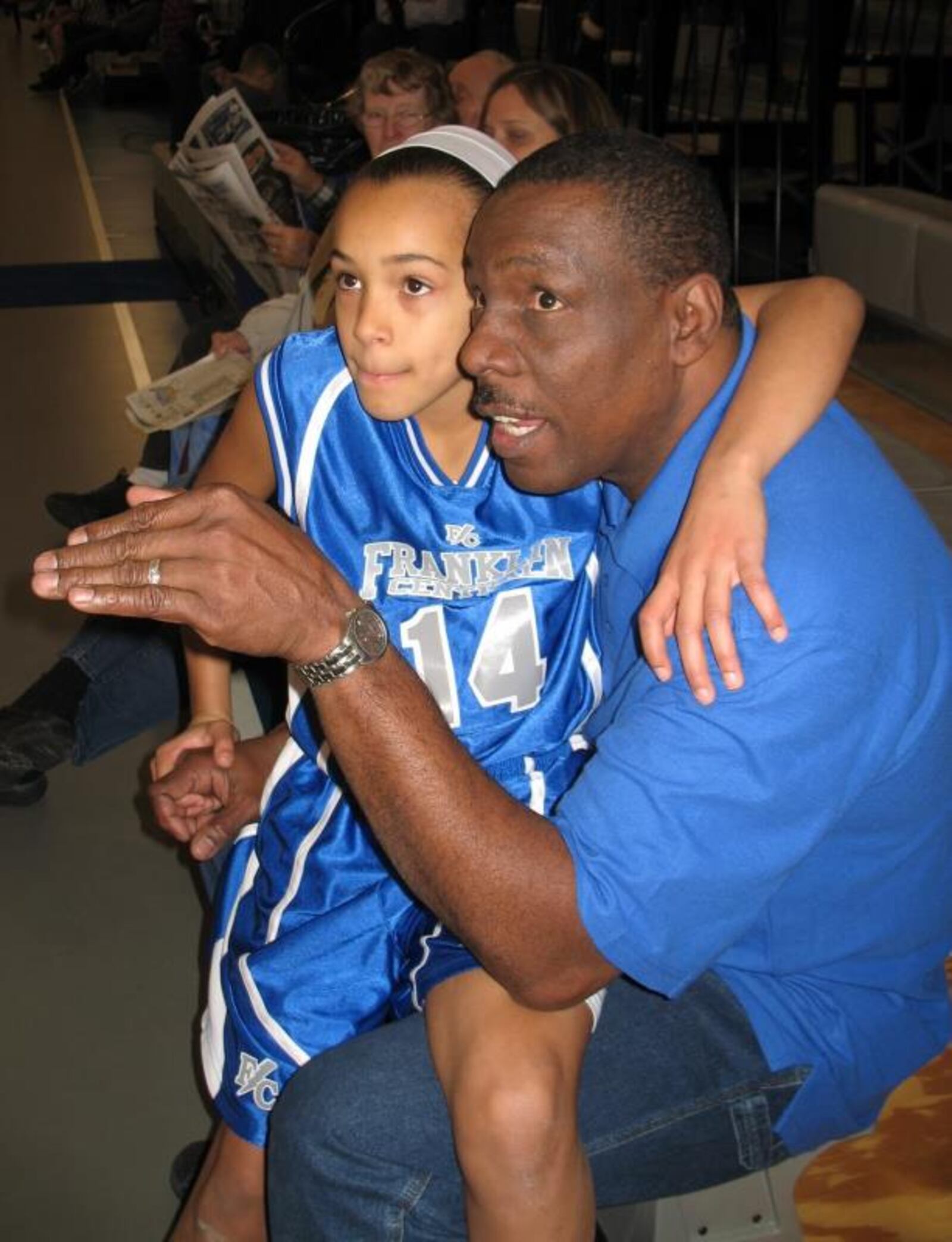 Patrick Loobie  talks basketball to his then 9-year-old daughter Rachel at an Indy Girls Hoops League event. CONTRIBUTED