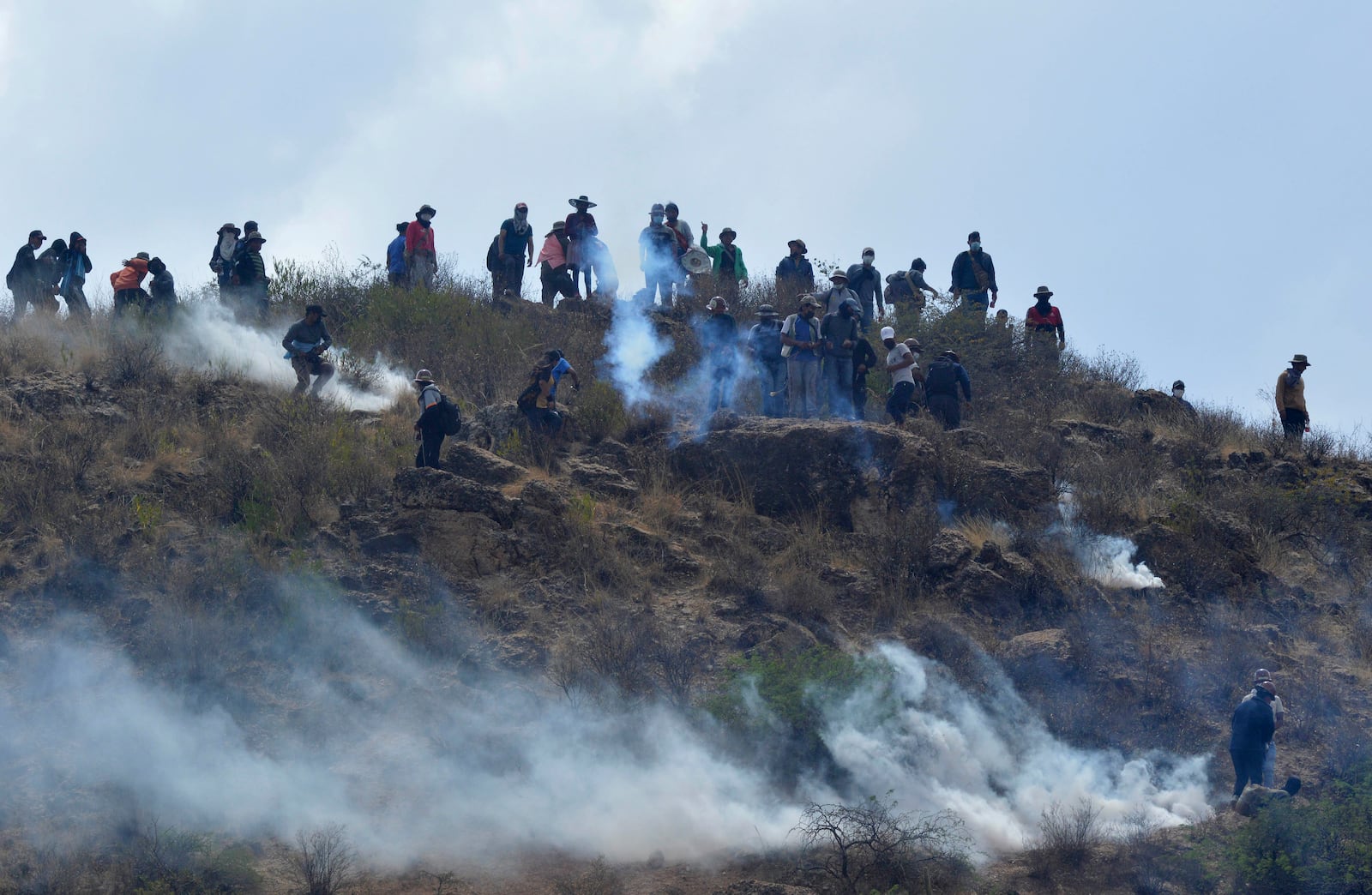 Supporters of former Bolivian President Evo Morales clash with police during a roadblock to pressure against him being prosecuted over allegations of minor abuse, near Cochabamba, Bolivia, Friday, Oct. 25, 2024. (AP Photo/Daniel Cartagena)