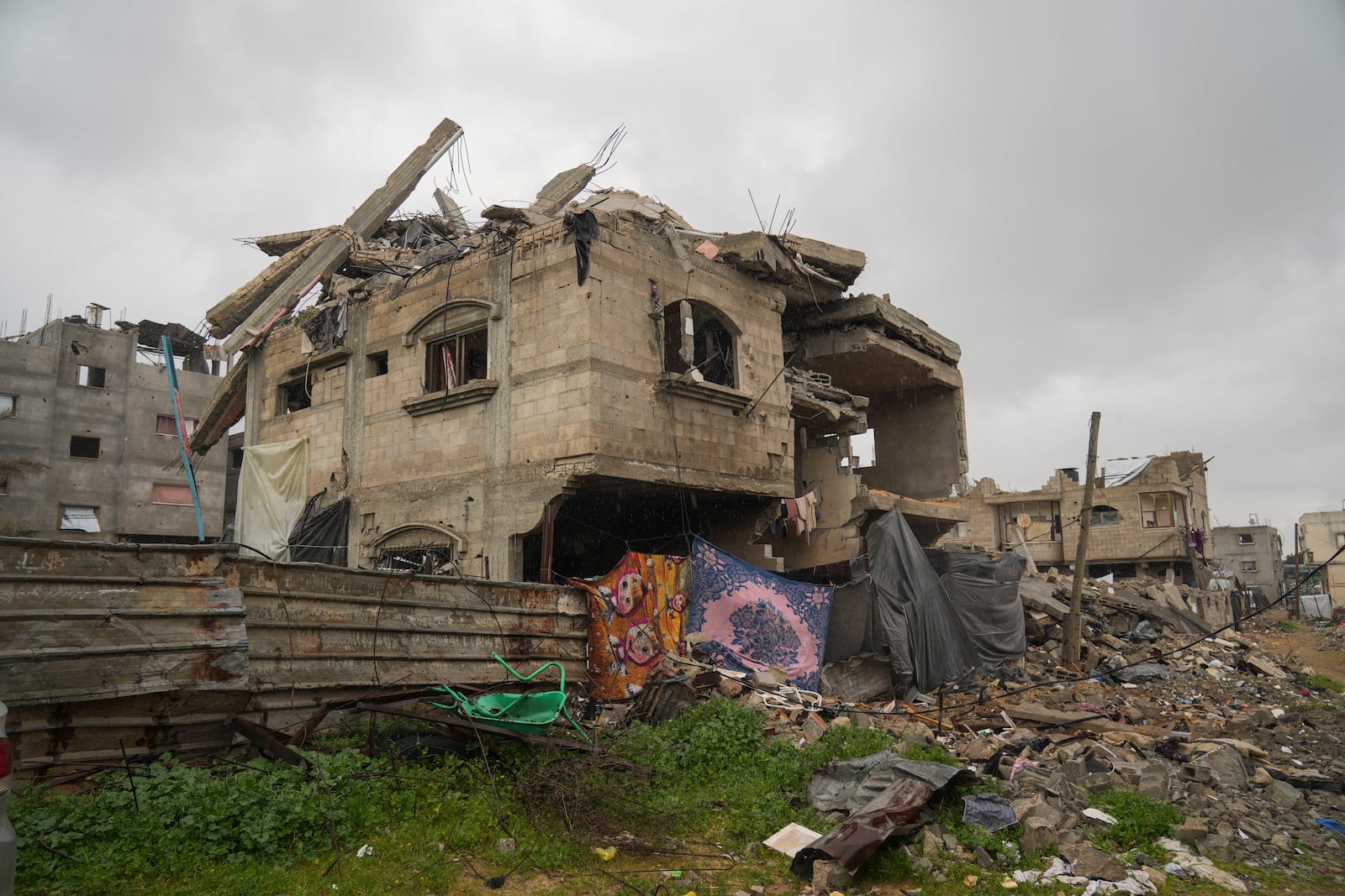 A four-story home belonging to the Tamboura family, which was struck by an Israeli airstrike on Oct. 20, 2023, stands in ruins in Beit Lahiya, northern Gaza Strip, Friday, Feb. 21, 2025. (AP Photo/Abdel Kareem Hana)