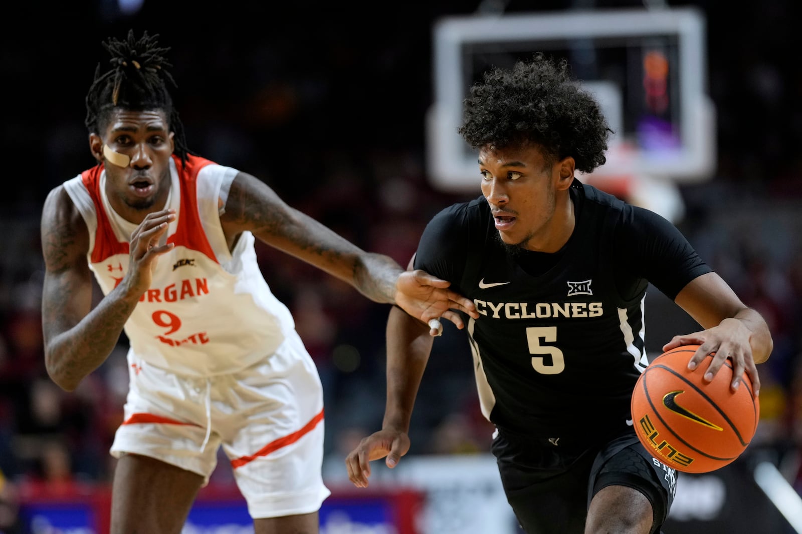 Iowa State guard Curtis Jones (5) drives past Morgan State forward Jaden Martin (9) during the second half of an NCAA college basketball game Sunday, Dec. 22, 2024, in Ames, Iowa. (AP Photo/Charlie Neibergall)