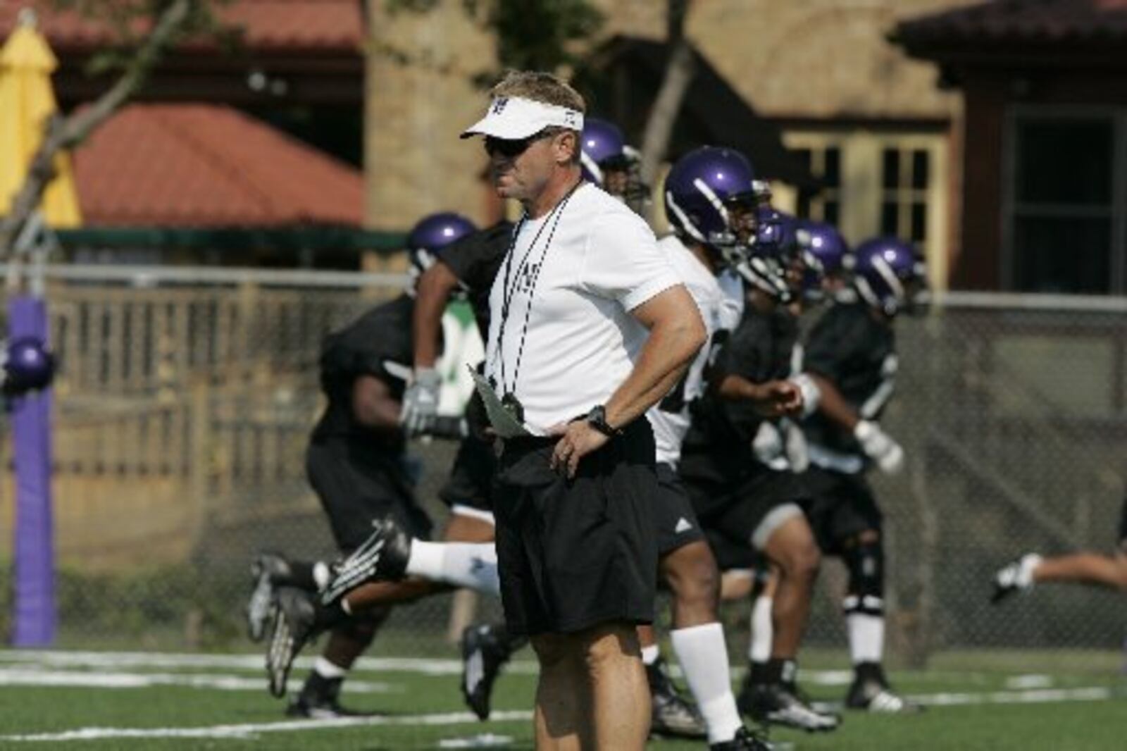 Northwestern football coach Randy Walker watches his players during practice in Evanston, Ill., in this Aug. 8, 2005, file photo. Walker died Thursday, June 30, 2006, of an apparent heart attack at the age of 52, according to school officials. Walker, who joined Northwestern in 1999, led the school to three bowl games and four seasons with at least six wins. (AP Photo/Jeff Roberson, File)