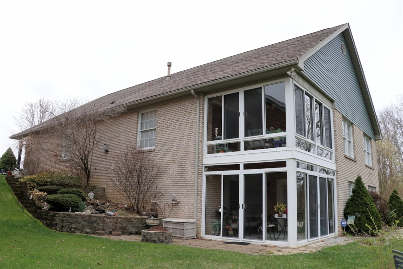 Both levels have enclosed patios with views of the woods.