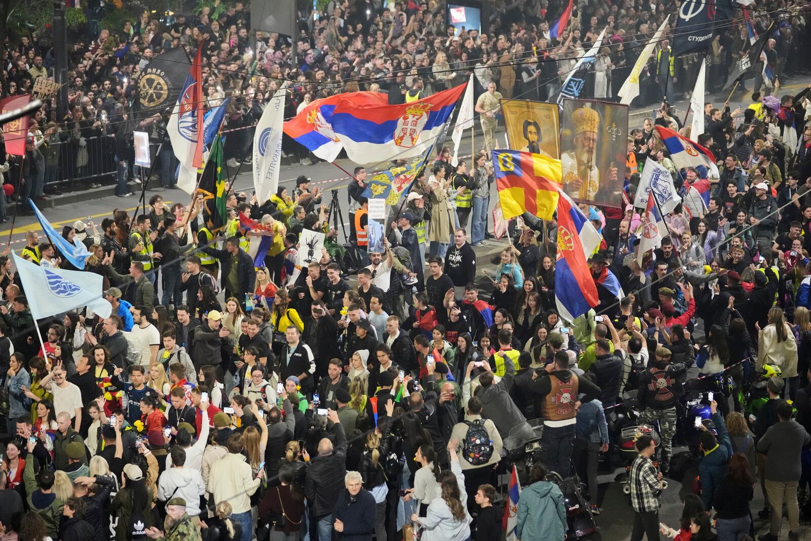 People welcome protesters from provinces who have arrived ahead of a major rally this weekend in downtown Belgrade, Serbia, Friday, March 14, 2025. (AP Photo/Darko Vojinovic)