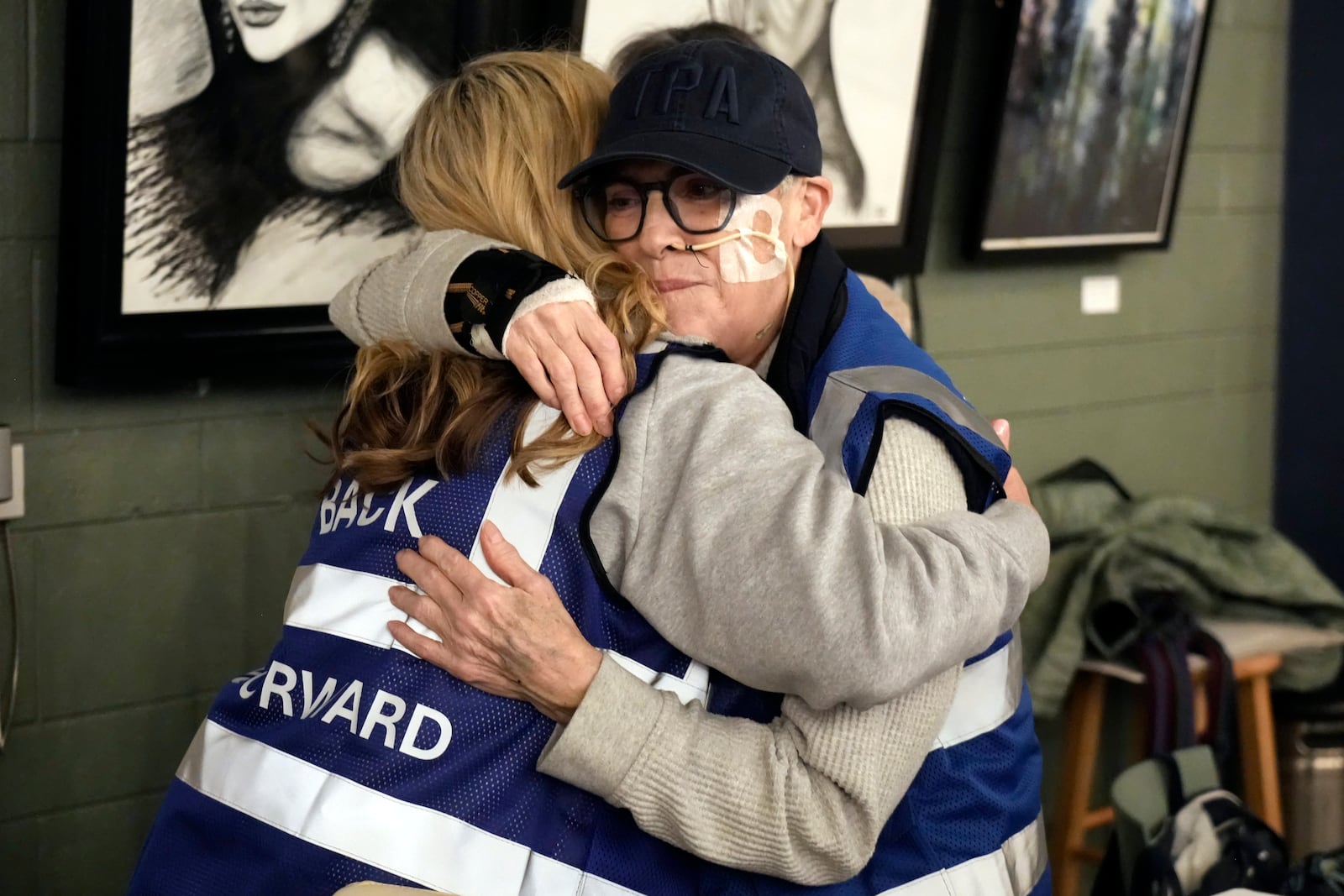 Ann Marie Dooley, left, hugs Kathy Fruge during a meeting of NC Forward in High Point, N.C., Tuesday, Jan. 14, 2025. The group is traveling to Washington to take part in the People's March on Jan. 18 ahead of the inauguration. (AP Photo/Chuck Burton)