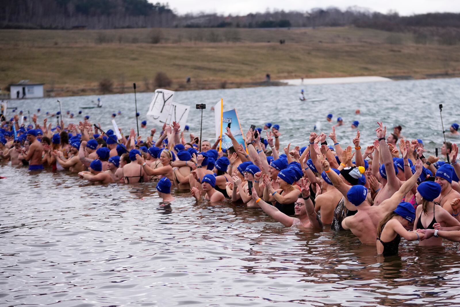 Some of 2461 polar swimmers wait in the water to set a world record for the largest polar bear dip at a lake in Most, Czech Republic, Saturday, March 1, 2025. (AP Photo/Petr David Josek)