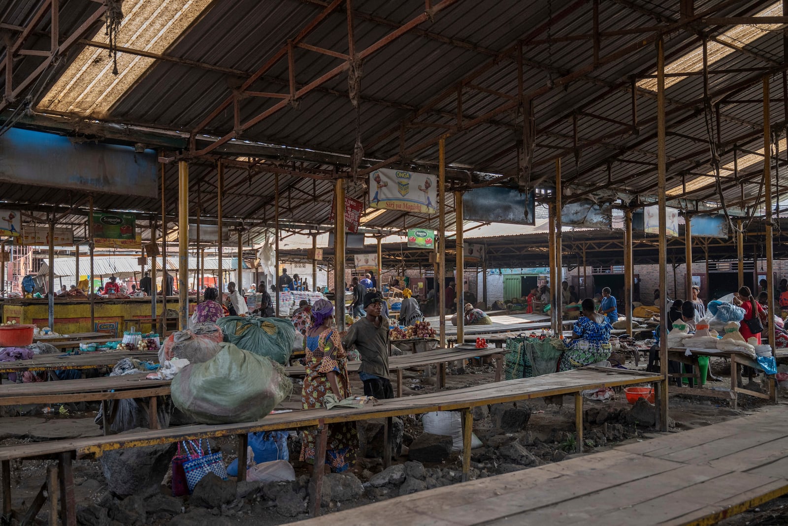 Merchants wait for customers at the Virunga market in Goma, Democratic Republic of Congo, Thursday, Feb. 27, 2025, one month after Rwanda-backed M23 rebels captured the city. (AP Photo/Moses Sawasawa)