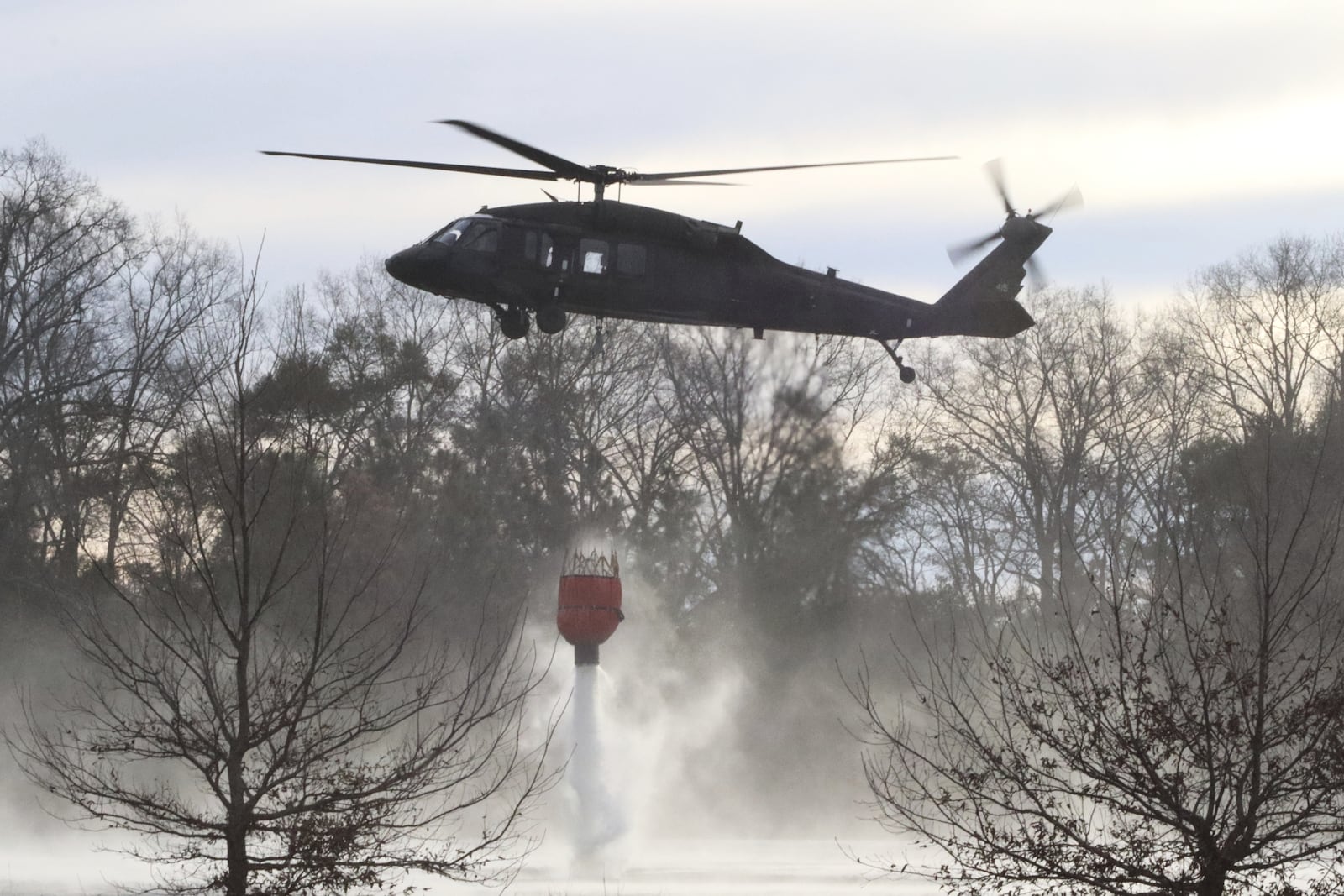 U.S. Army soldiers use Blackhawk helicopters to assist the South Carolina Forestry Commission and the South Carolina Department of Natural Resources with wildfire containment in Horry County, S.C., Sunday, March 2, 2025. (Elizabeth A. Schneider/U.S. Army via AP)