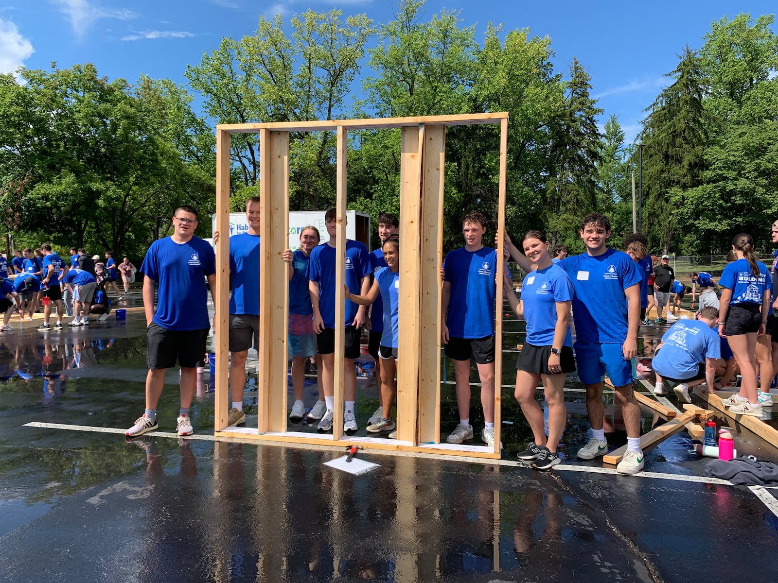 More than 400 University of Dayton students braved pouring rain Sunday to build wood frame walls for Dayton Habitat for Humanity. LONDON BISHOP/STAFF