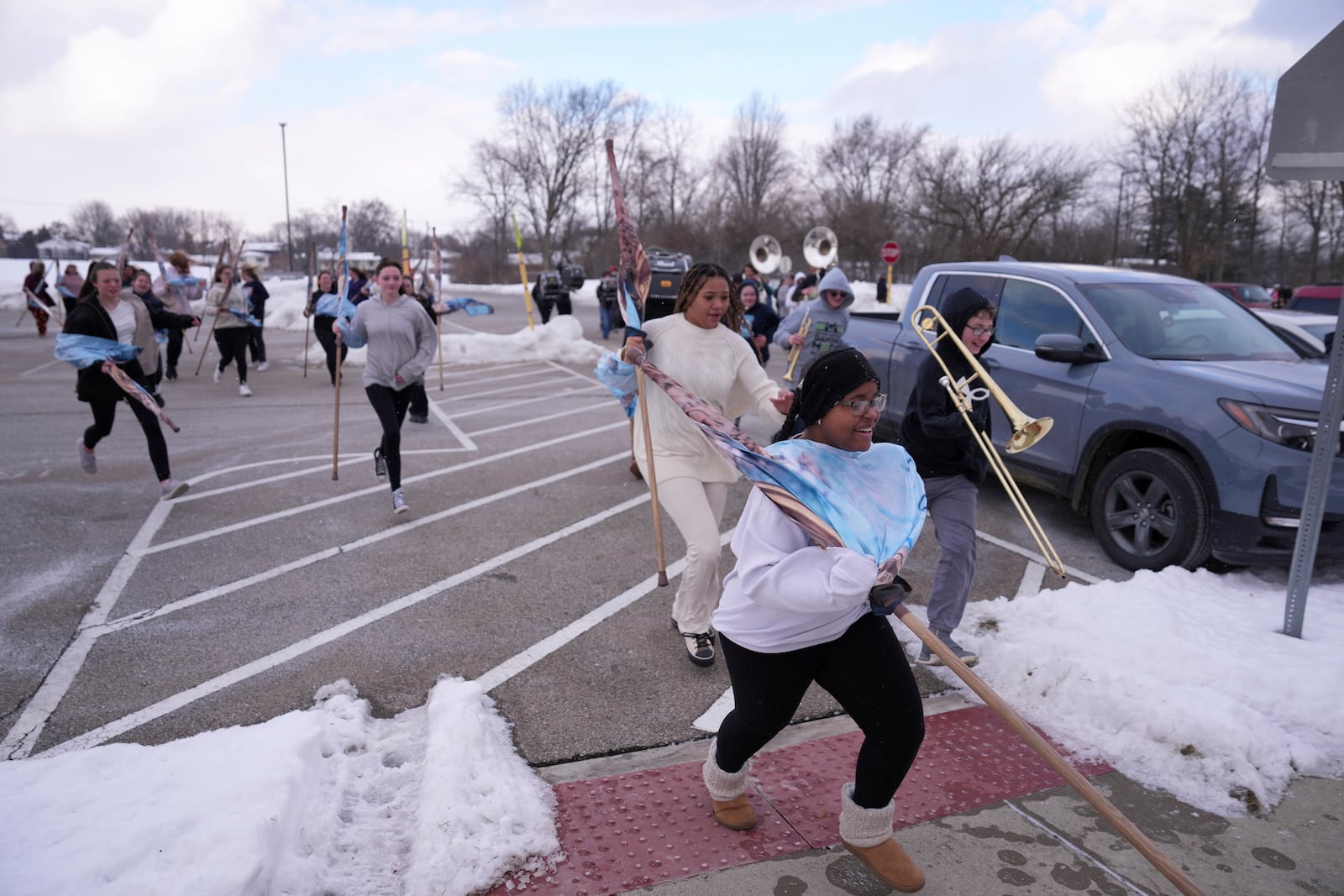 Middletown High School band students escape the cold weather after practicing outside, Tuesday, Jan. 14, 2025, in Middletown, Ohio. The band is set to participate in the inauguration of President-elect Donald Trump on Jan. 20. Middletown is the hometown of Vice President-elect JD Vance.(AP Photo/Kareem Elgazzar)