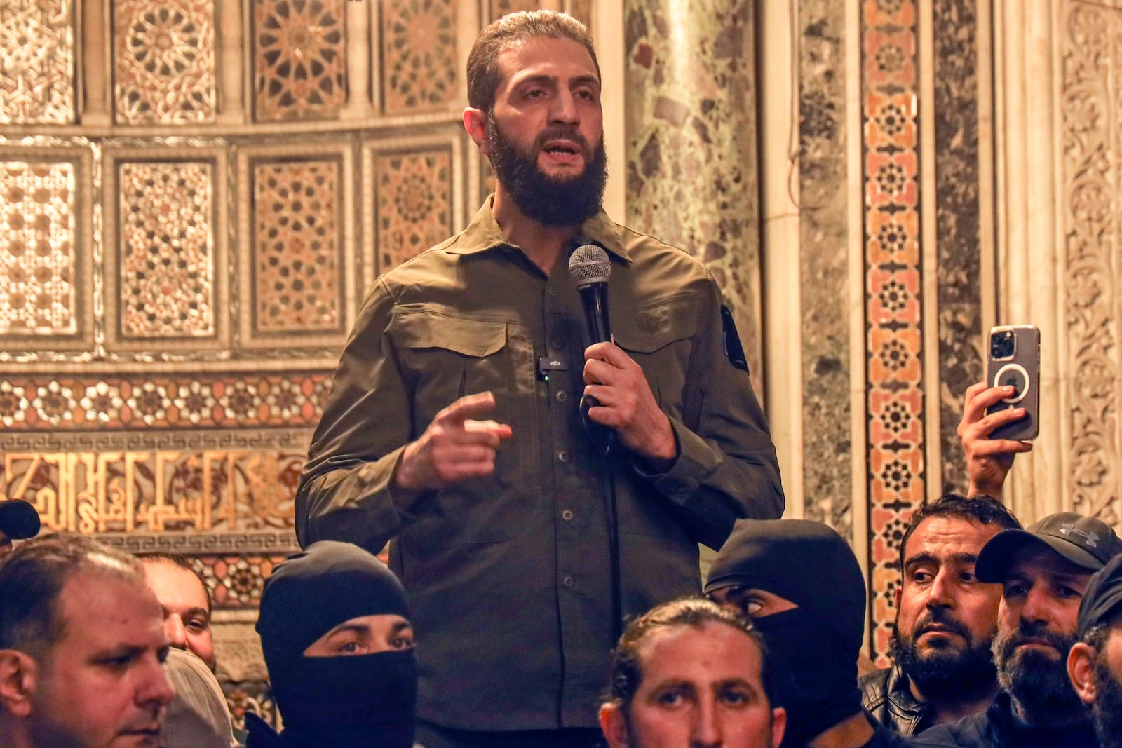 Abu Mohammed al-Golani speaks at the Umayyad Mosque in Damascus Sunday, Dec. 8, 2024. (AP Photo/Omar Albam)