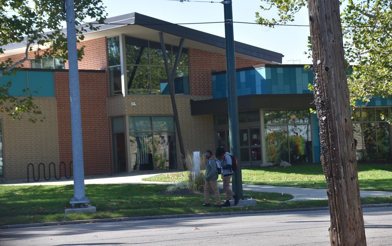 A couple of boys walk by the Dayton Metro Library Southeast Branch at 21 Watervliet Ave. CORNELIUS FROLIK / STAFF