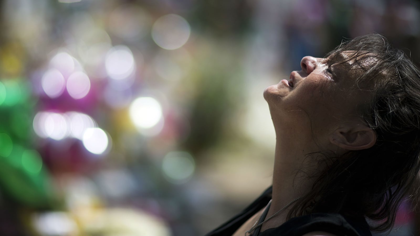 Auburn Sandstrom cries while praying June 22, 2015, at a sidewalk memorial in memory of the nine shooting victims at Emanuel AME Church, in Charleston, S.C. Dylann Roof, the white supremacist who gunned down the victims, staged a hunger strike on death row in February 2020. Attorneys for Roof, 25, are appealing his conviction and death sentence.