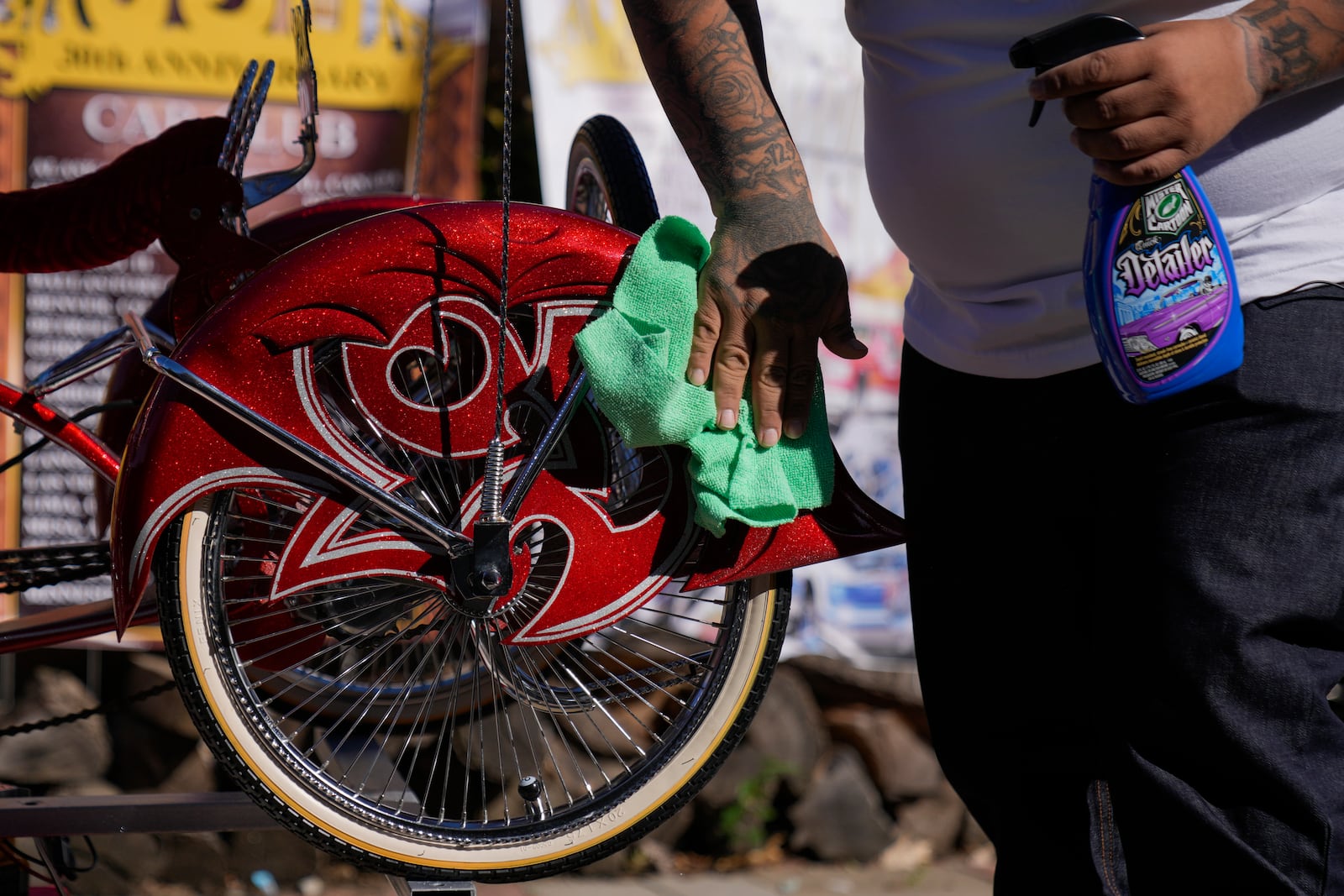 Luis Martinez, 29, a member of the Uso Chicago Car Club, cleans his custom-built lowrider bike Saturday, Sept. 21, 2024, in Mishawaka, Ind. (AP Photo/Erin Hooley)