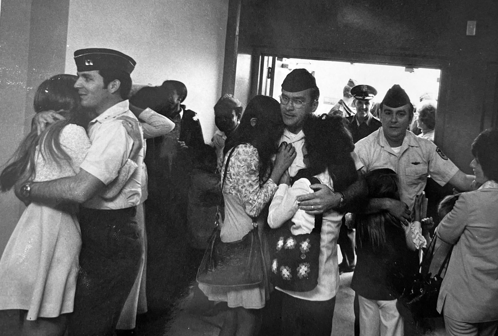 Snedegar (far right) and two of his fellow crew members reunite with their families after the crash. With Snedegar is his wife Barbara and daughter Dawn at Travis Air Force Base.