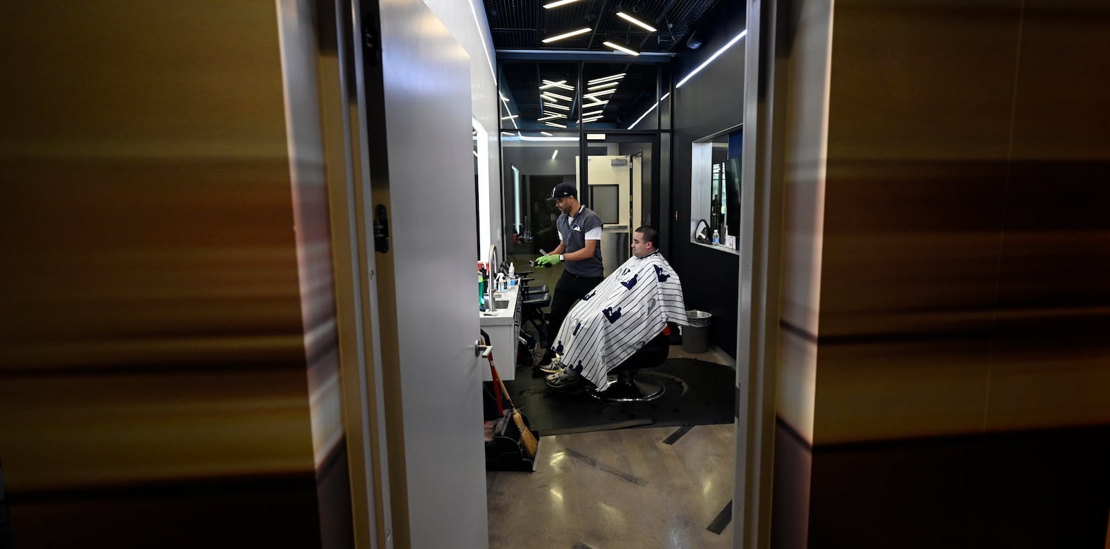 A New York Yankees clubhouse attendant sits in a barber's chair during a tour of the upgraded team spring training facilities Thursday, Feb. 13, 2025, at George M. Steinbrenner Field in Tampa, Fla. (AP Photo/Steve Nesius)