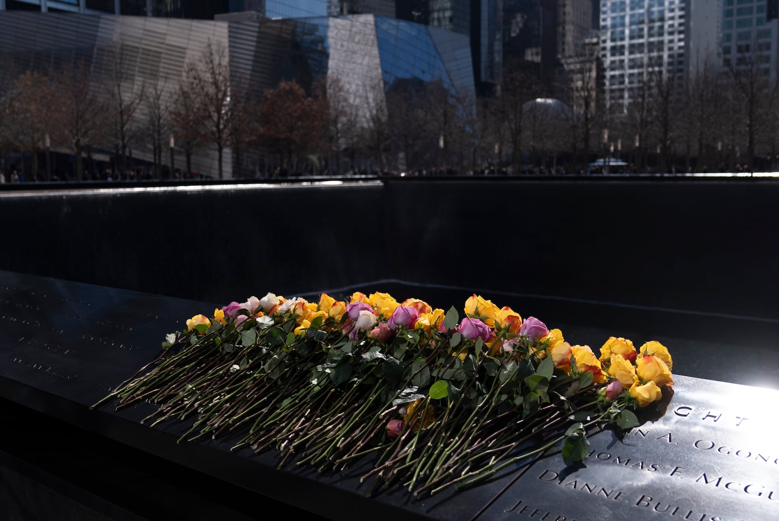 Flowers rest on names of the deceased during a ceremony marking the anniversary of the 1993 World Trade Center bombing at the 9/11 Memorial, Wednesday, Feb. 26, 2025, in New York. (AP Photo/John Minchillo)