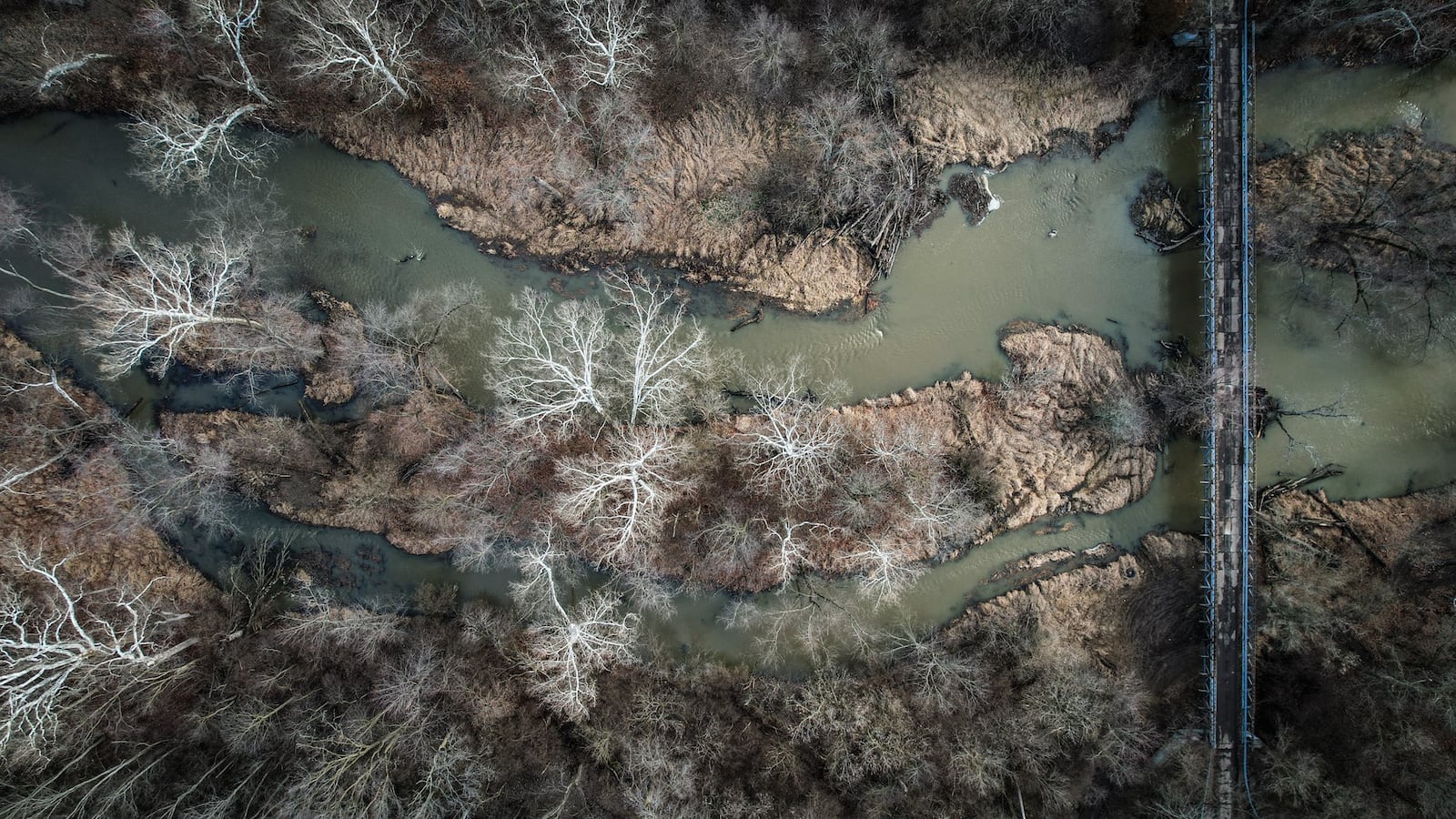 An overhead view of a small channel of the Great Miami River immediately north of the Cargill plant in North Dayton. In late 2023, corn gluten meal spilled from the plant into the water. JIM NOELKER/STAFF