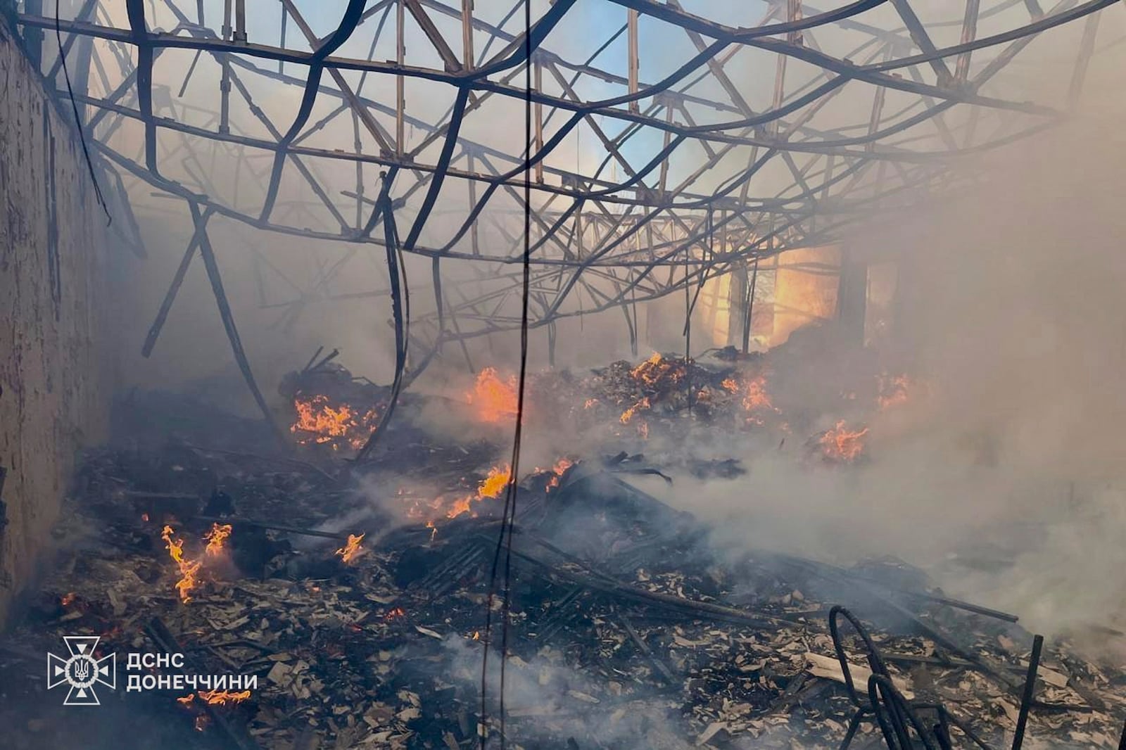 In this photo provided by the Ukrainian Emergency Service, firefighters put out the fire at a storehouse following a Russian attack in Kostiantynivka, Donetsk region, Ukraine, Thursday, March 20, 2025. (Ukrainian Emergency Service via AP)