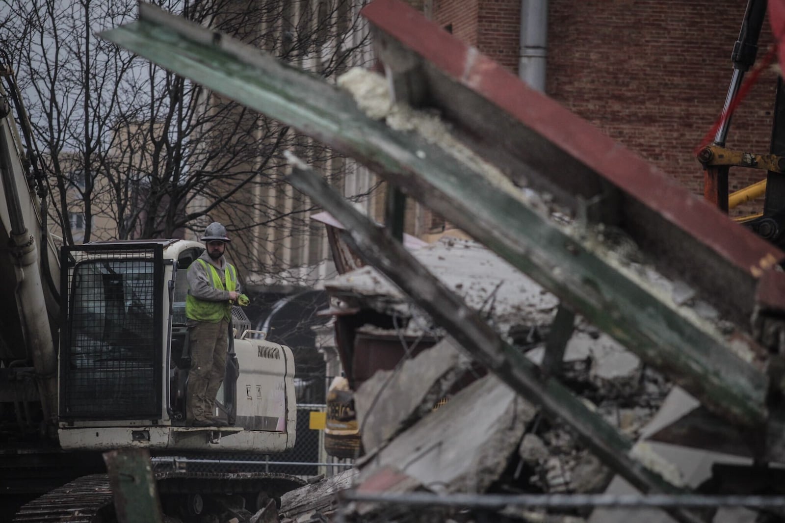 Demolition work did not go as planned Monday at the former Wright State University Kettering Center in downtown Dayton. Large metal beams, bricks, concrete and other building debris collapsed onto Monument Avenue, taking down RTA lines and heavily damaging a sculpture at RiverScape MetroPark across the street.