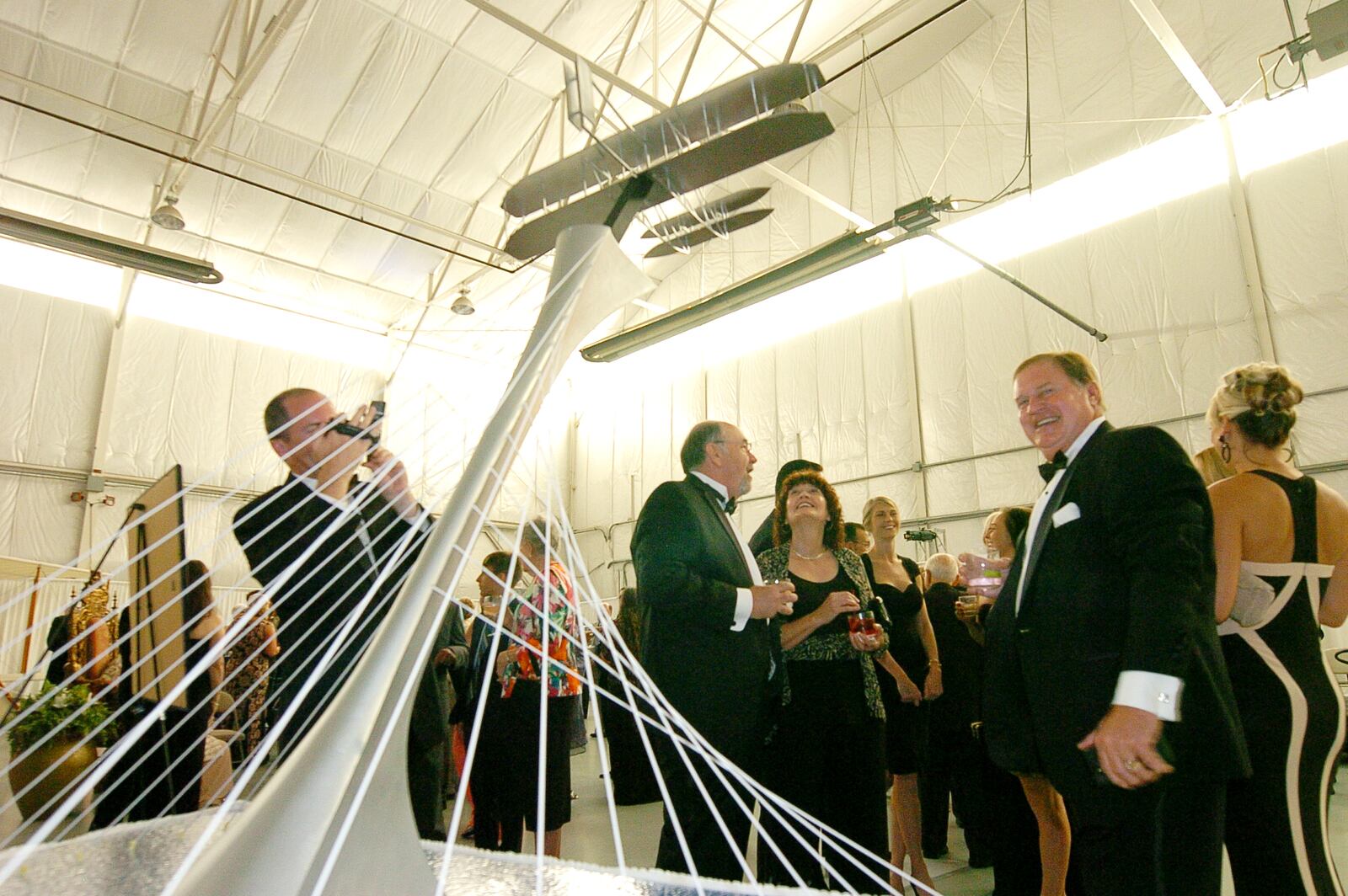 Zoe Dell Nutter celebrates her 100th birthday during a fund raising event to construct a monument horning the Wright Brothers, which would be erected at the crossroads to I-70 and I-75 on Saturday evening 6/20/2015 where hundreds attend the event at the Commanders Aero�s hanger located at the Dayton-Wright Brothers Airport located in Miami Twp.,the display model of the Triumph of Flight was receiving a lot of attention CONTRIBUTED PHOTO/CHARLES CAPERTON