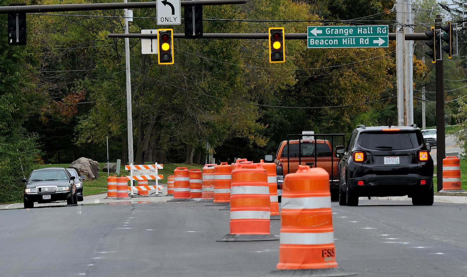 Orange barrels line Indian Ripple Road near Grange Hall Road in Beavercreek during road paving work Wednesday Oct 27, 2021. MARSHALL GORBY\STAFF