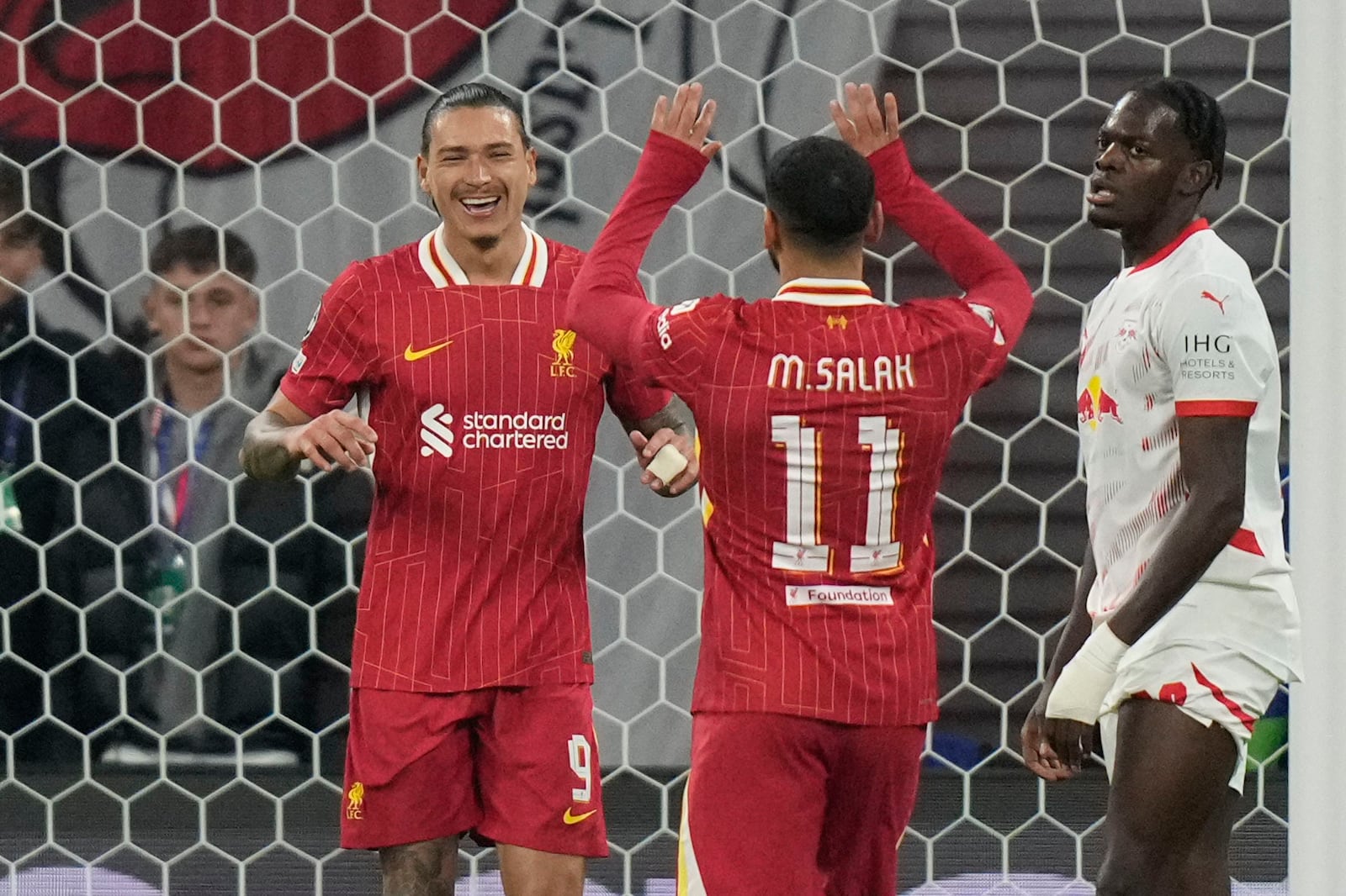 Liverpool's Darwin Nunez, left, celebrates with Liverpool's Mohamed Salah after scoring the opening goal during the Champions League opening phase soccer match between RB Leipzig and Liverpool at the RB Arena in Leipzig, Germany, Wednesday, Oct. 23, 2024.(AP Photo/Matthias Schrader)