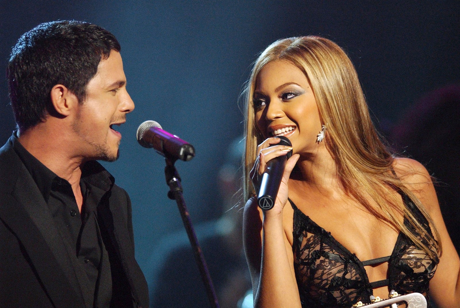 FILE - Spanish singer Alejandro Sanz, left, and Beyonce Knowles, of Destiny's Child, perform during the 44th Annual Grammy Awards on Feb. 27, 2002, in Los Angeles. (AP Photo/Kevork Djansezian, File)