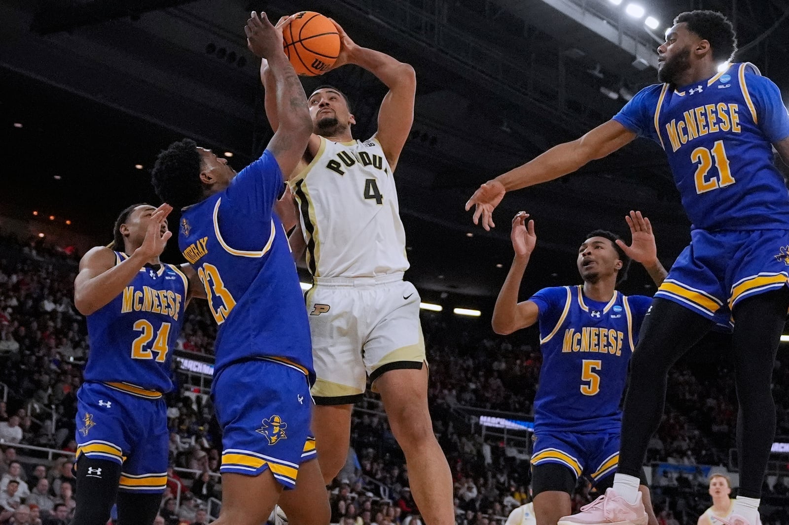 Purdue forward Trey Kaufman-Renn (4) is surrounded by McNeese State players on a shot during the second half in the second round of the NCAA college basketball tournament, Saturday, March 22, 2025, in Providence, R.I. (AP Photo/Charles Krupa)